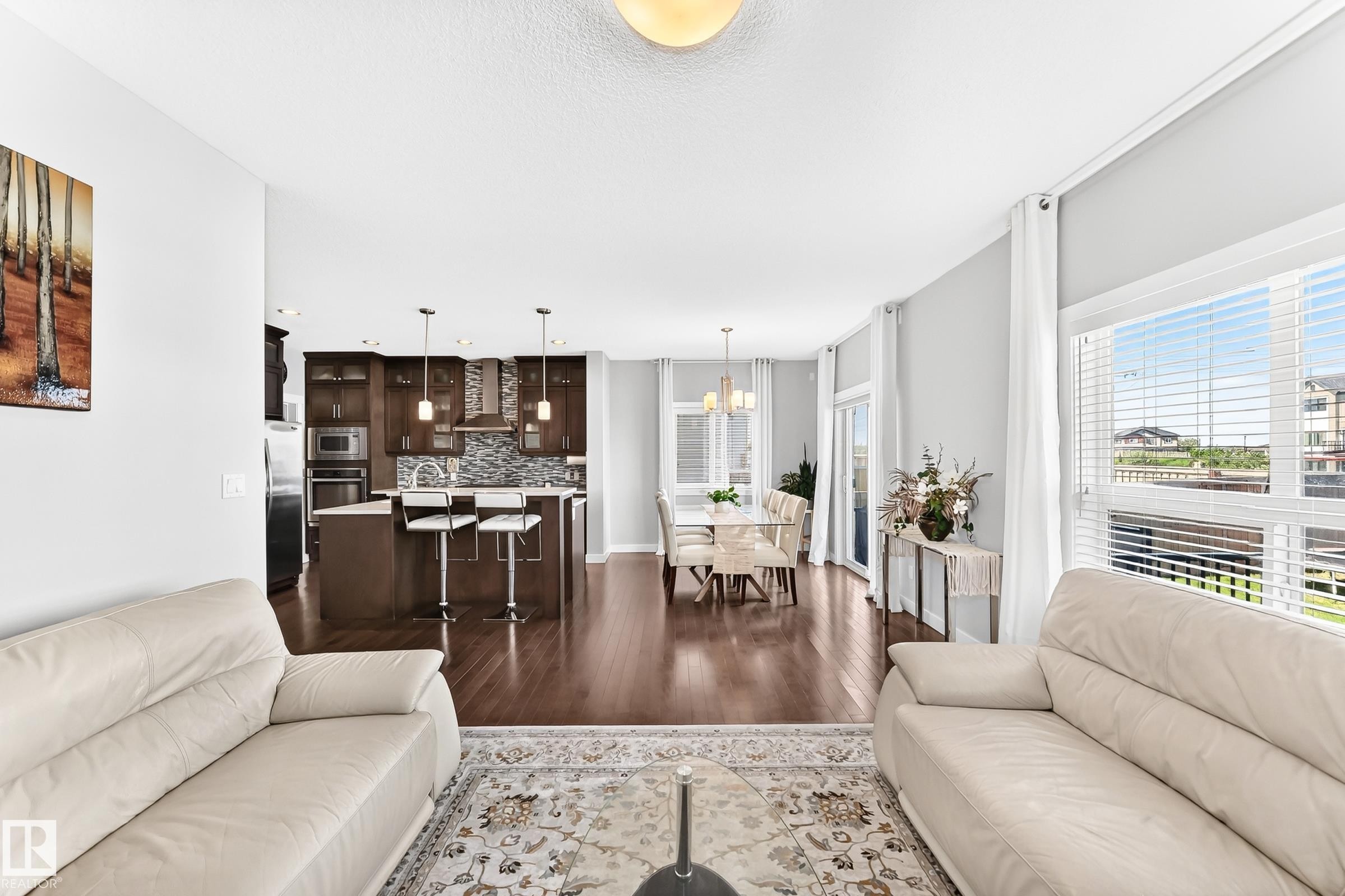 Open-concept main living area featuring dark wood-finish flooring - 3672 Claxton Place Sw, Edmonton, AB