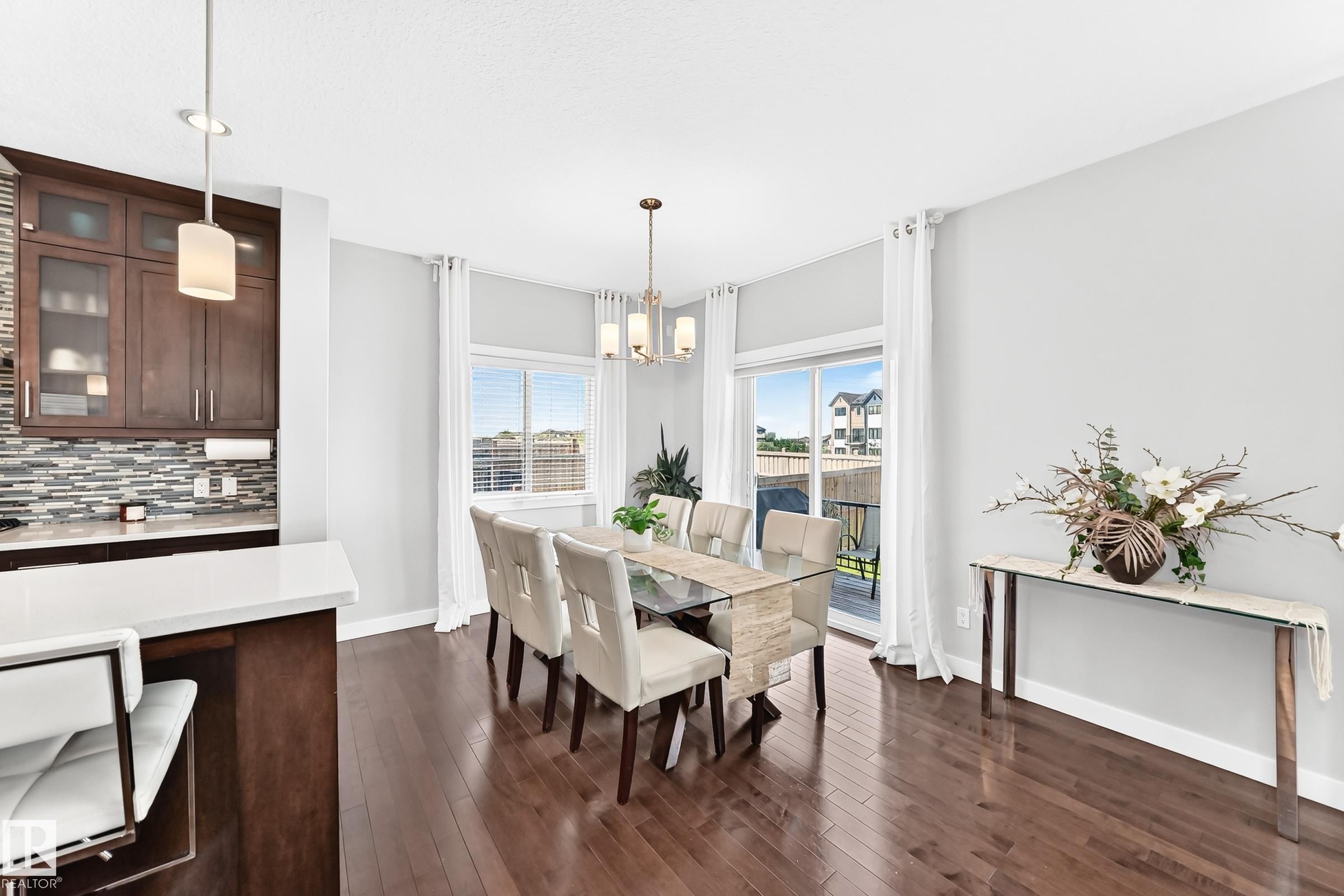Open concept dining area with dark wood-finish flooring - 3672 Claxton Place Sw, Edmonton, AB