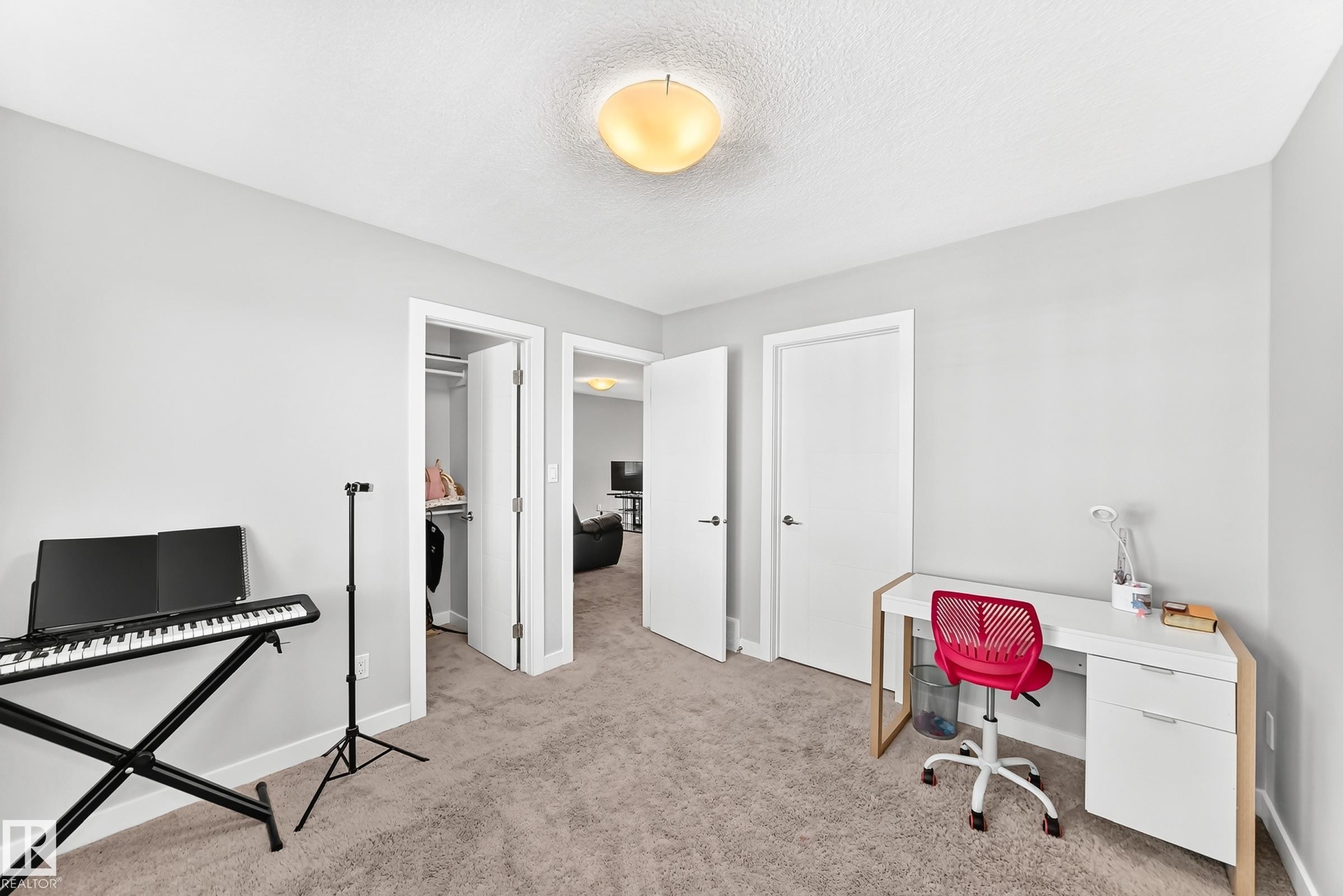 Neutral tone wall paint, light gray carpet, white trim, and a semi-flush mount ceiling light - 3672 Claxton Place Sw, Edmonton, AB
