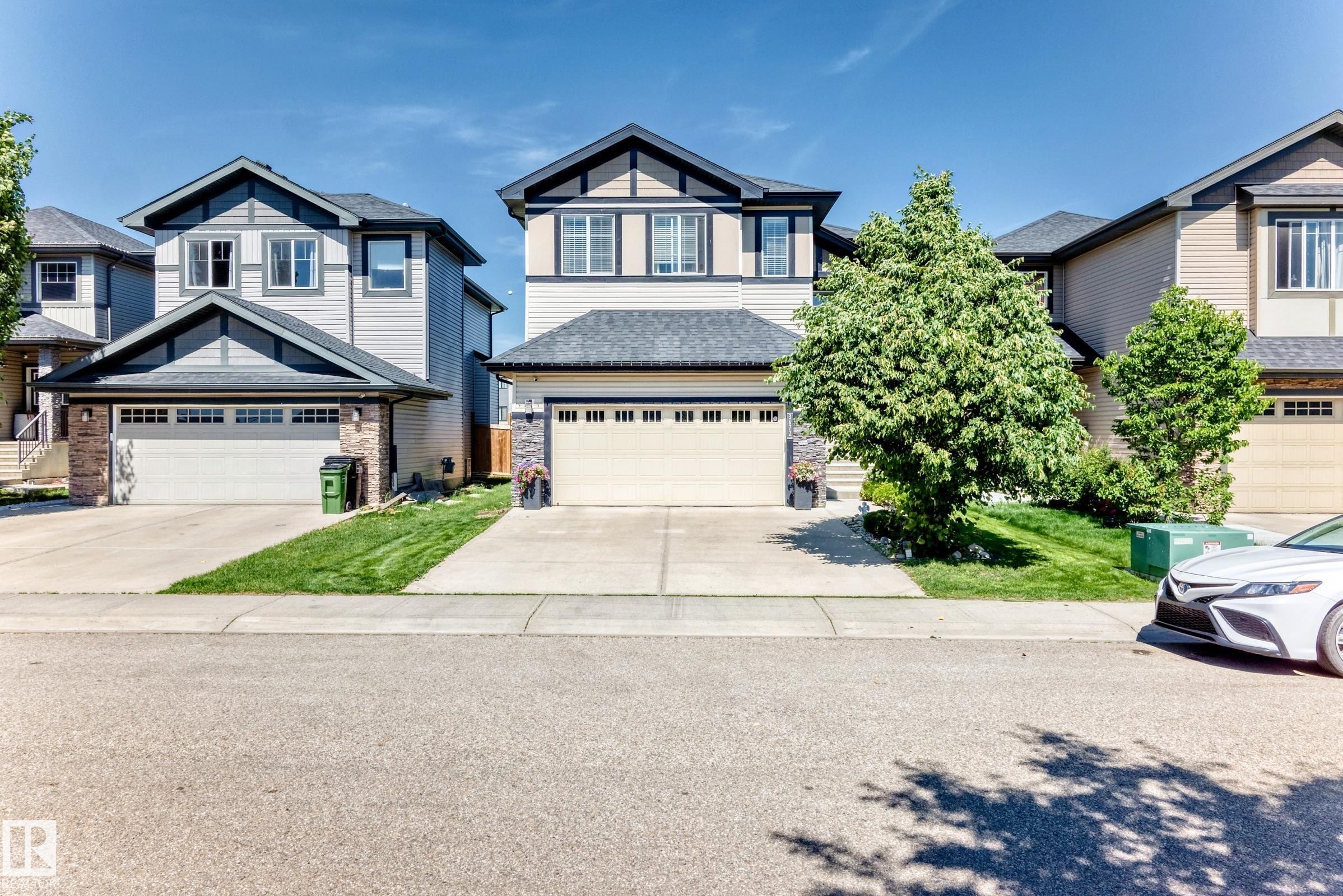 Contemporary two-story home featuring light-colored siding, dark trim accents, and a prominent front-facing gable - 3672 Claxton Place Sw, Edmonton, AB