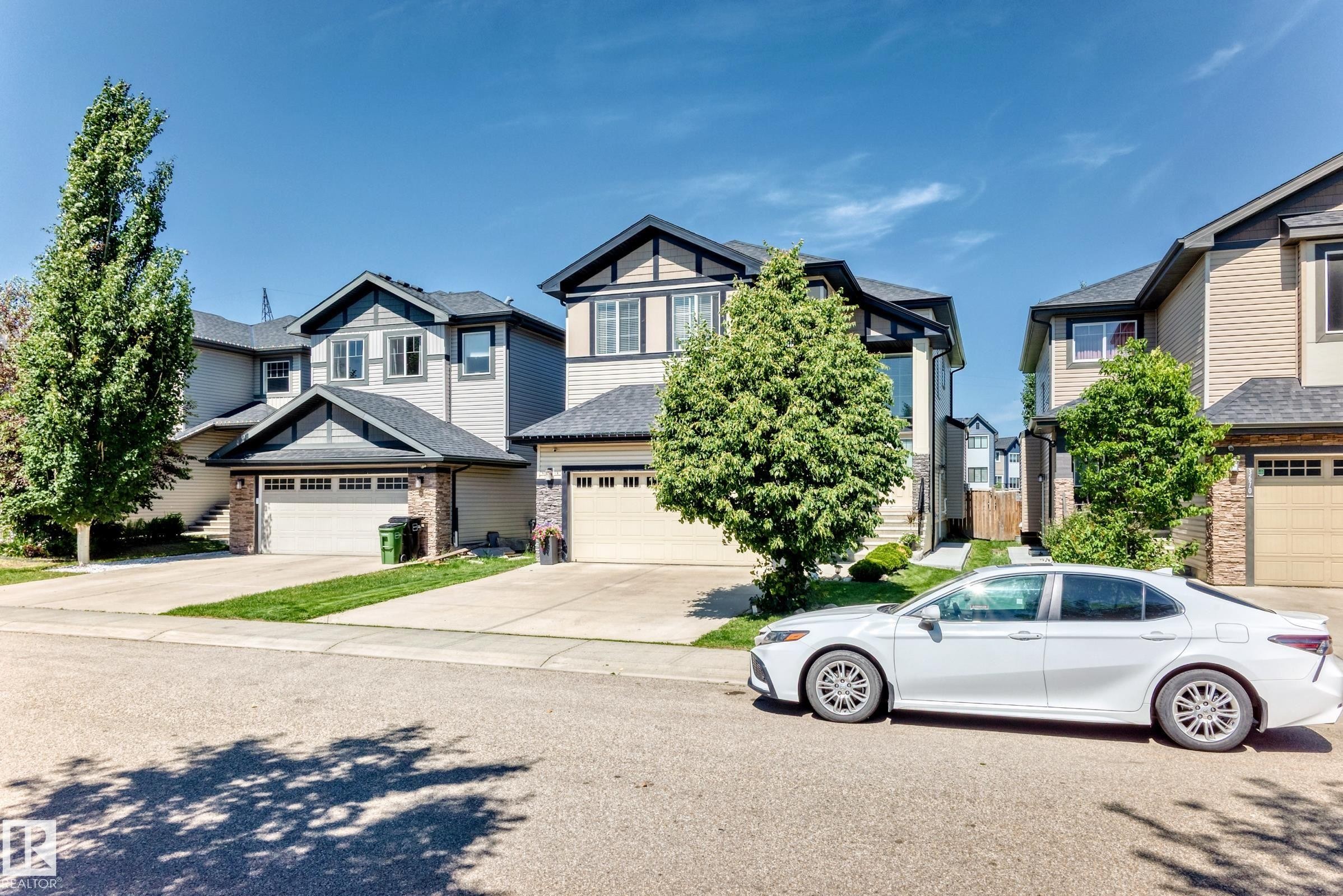 Contemporary two-story residence featuring light-toned siding and dark trim accents - 3672 Claxton Place Sw, Edmonton, AB