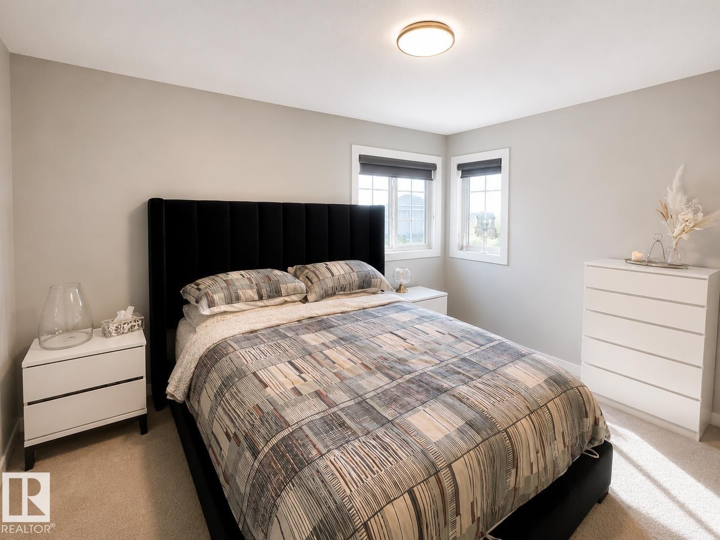 Bedroom with light neutral walls, two windows with dark roller shades, and a flush mount ceiling light fixture - 1004 Huckell Pl Sw, Edmonton, AB - Indoor Photo Showing Bedroom