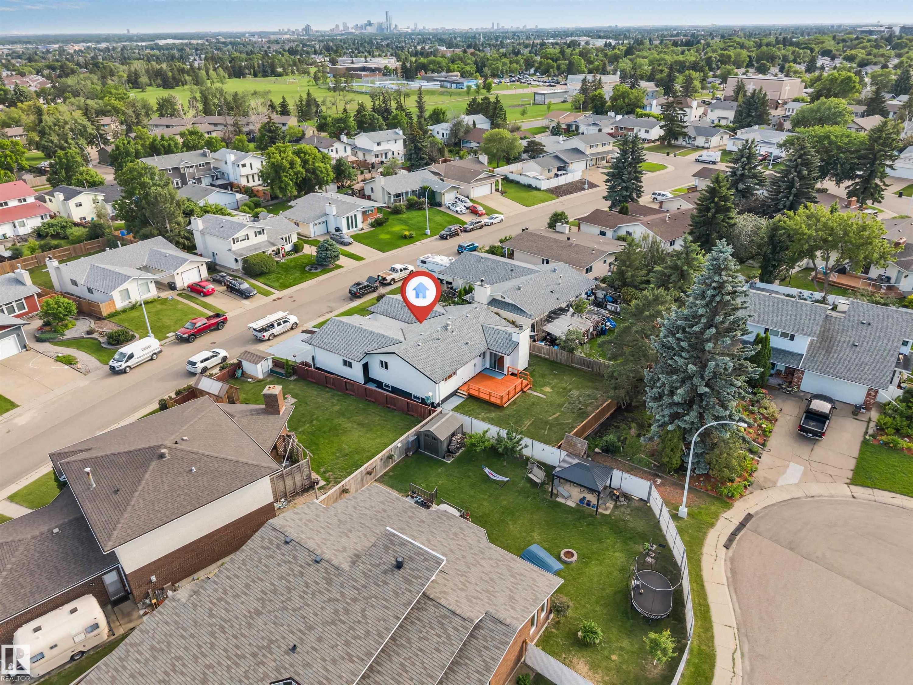 Aerial view of a residential property with a light grey shingle roof and a spacious backyard - 5512 150 Avenue, Edmonton, AB