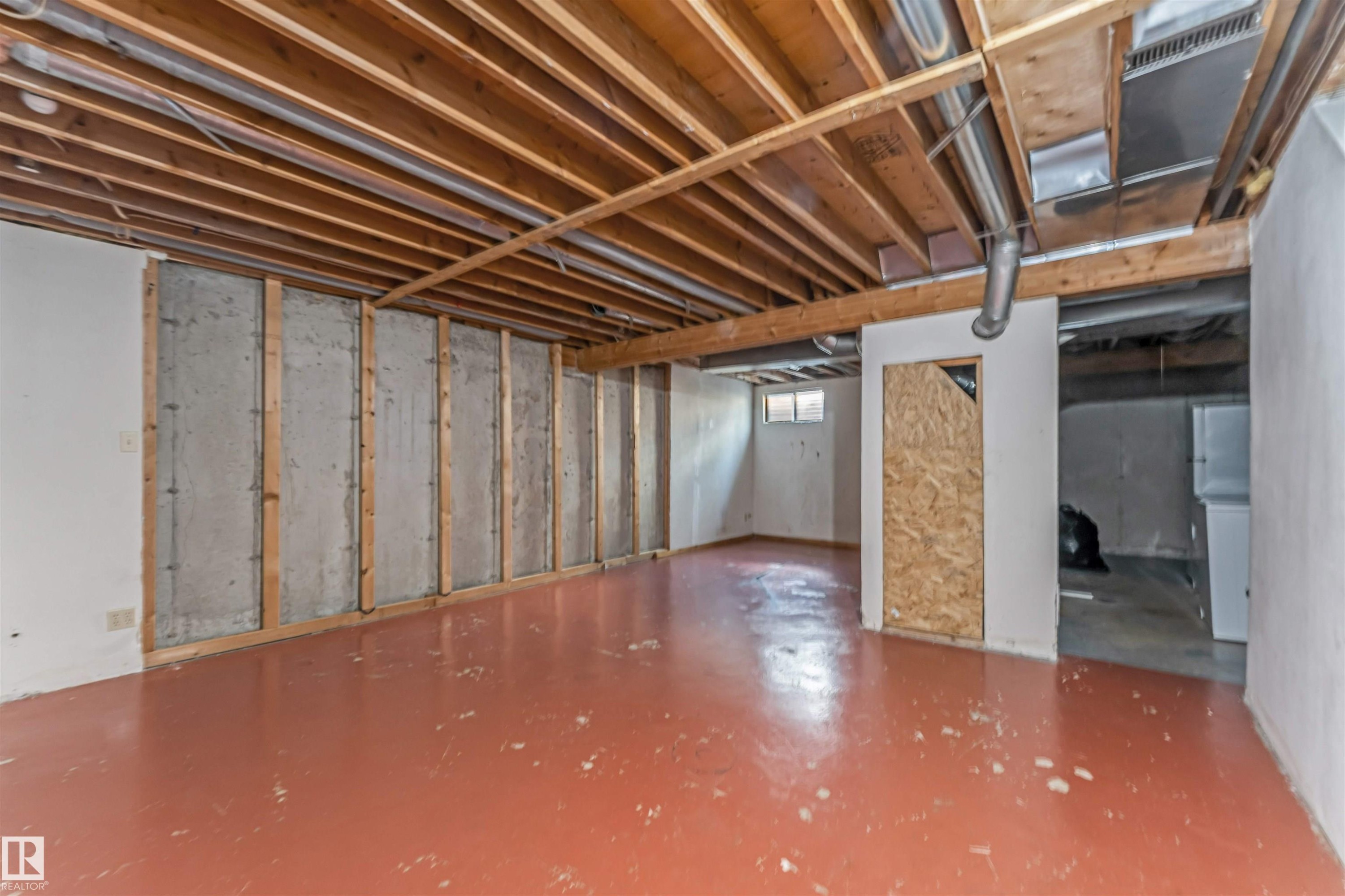 Spacious unfinished basement with exposed wood joists and concrete walls framed for future finishing - 24 1651 46 Street, Edmonton, AB