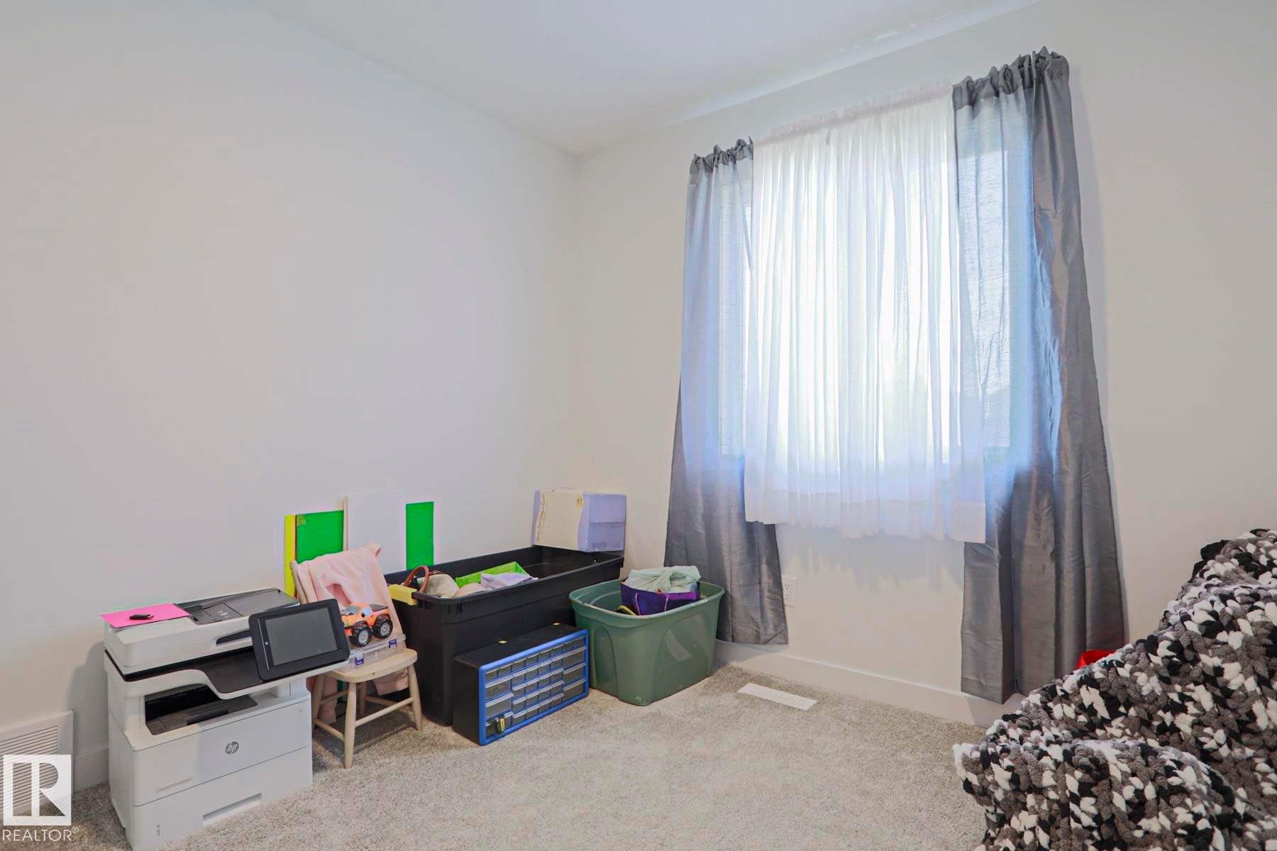 Room featuring light gray carpeting and white baseboards - 33 Eton Link, Spruce Grove, AB