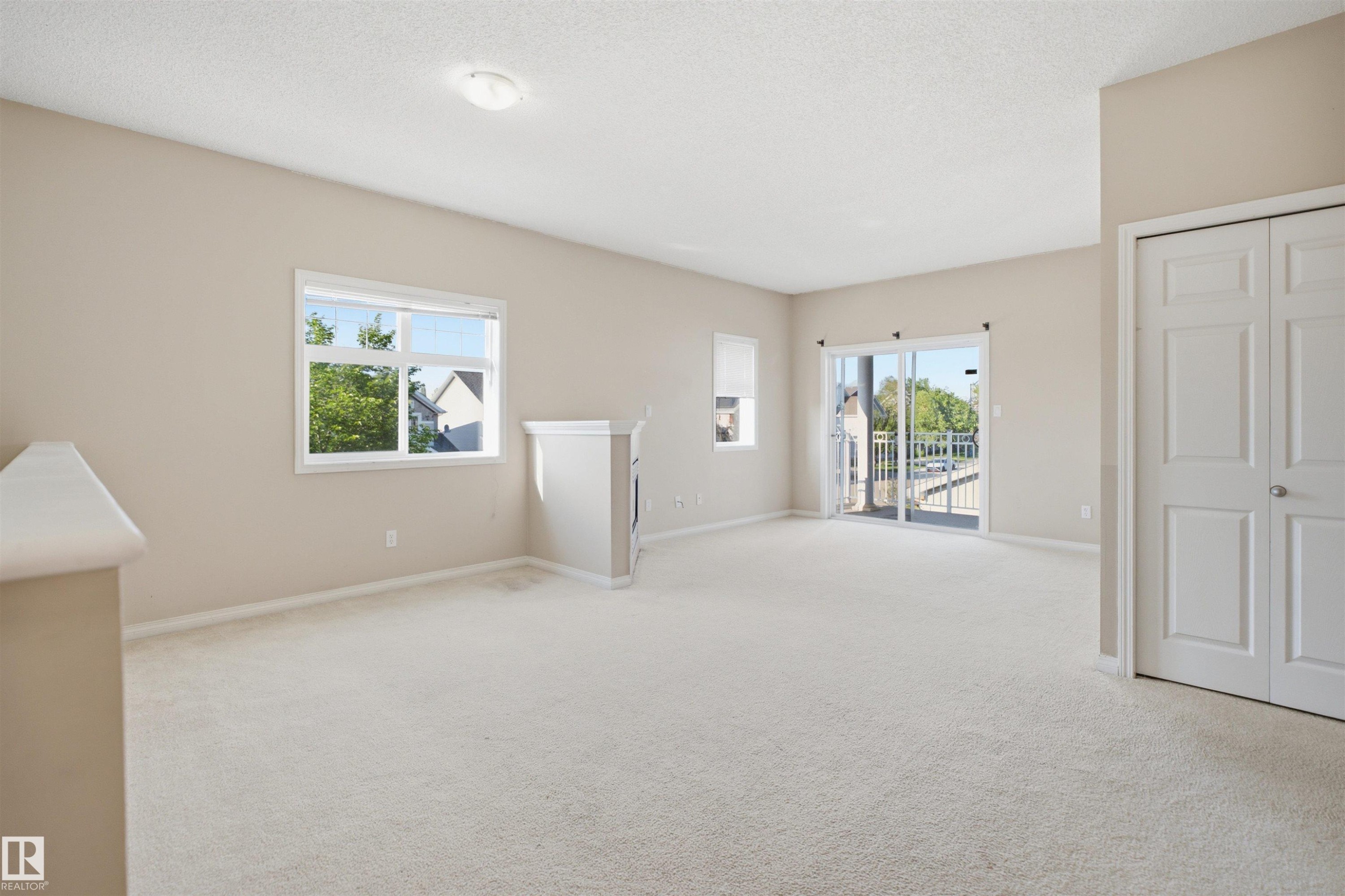 Spacious room featuring light-colored carpeting and neutral wall tones - 95 3040 Spence Wynd, Edmonton, AB
