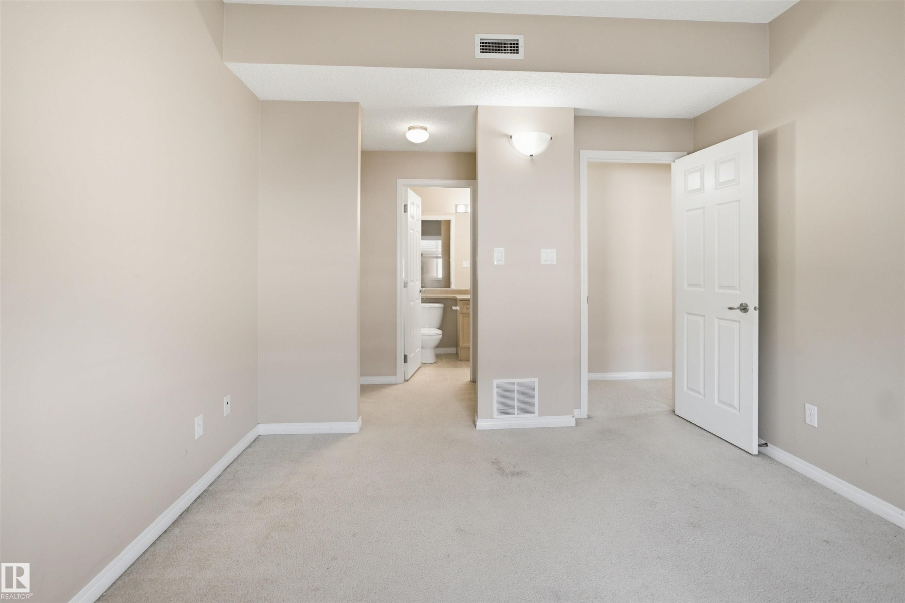 Neutral-toned walls and light carpeting create a versatile interior - 95 3040 Spence Wynd, Edmonton, AB