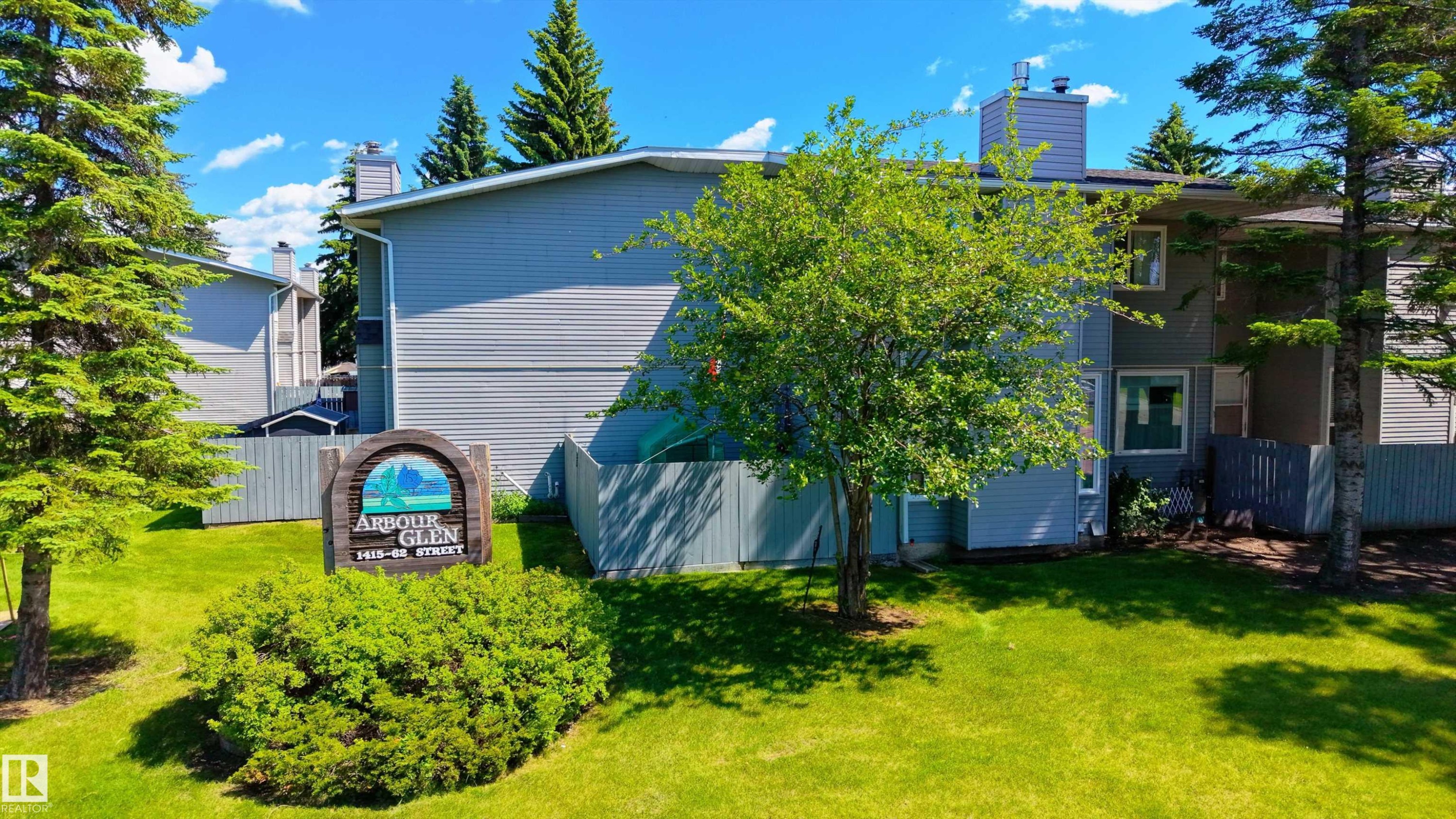 Multi-level building with gray siding and white trim - 10 1415 62 Street, Edmonton, AB
