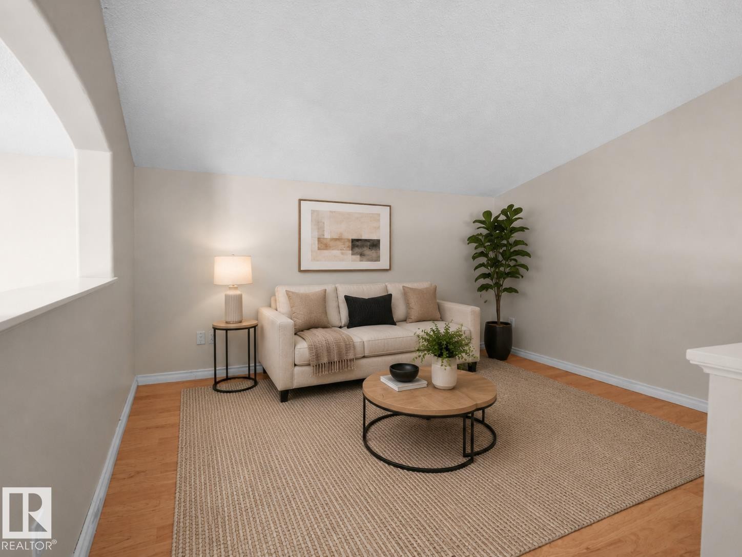 Living area with wood-finish flooring and neutral wall tones - 1855 Mill Woods Rd E Nw, Edmonton, AB
