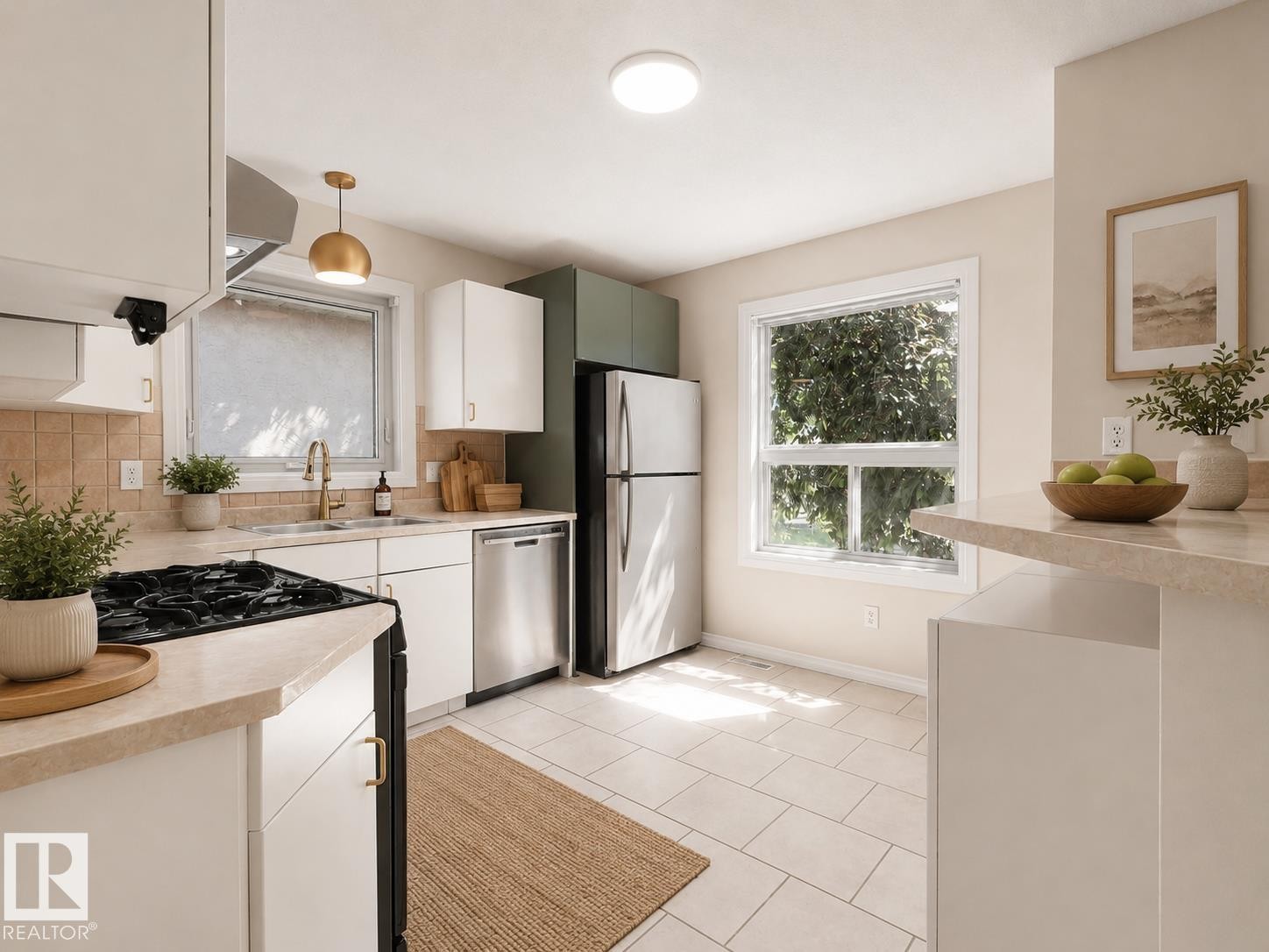 Kitchen featuring light-toned tile flooring, white cabinetry with brass hardware, stainless steel appliances, and a tiled backsplash - 1855 Mill Woods Rd E Nw, Edmonton, AB