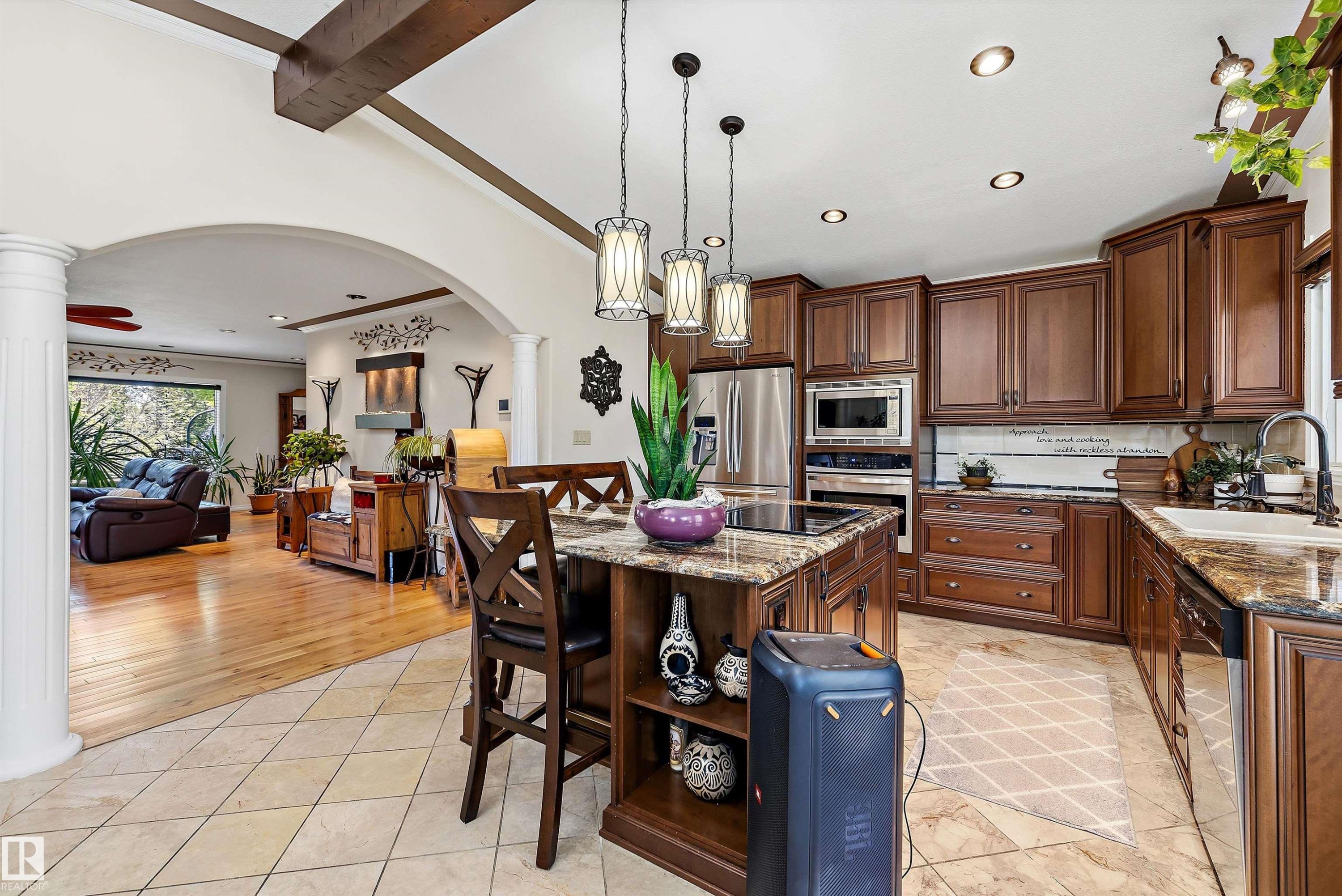 Gourmet kitchen with rich wood cabinetry, granite countertops, and stainless steel appliances - 11124 110A Avenue Nw, Edmonton, AB