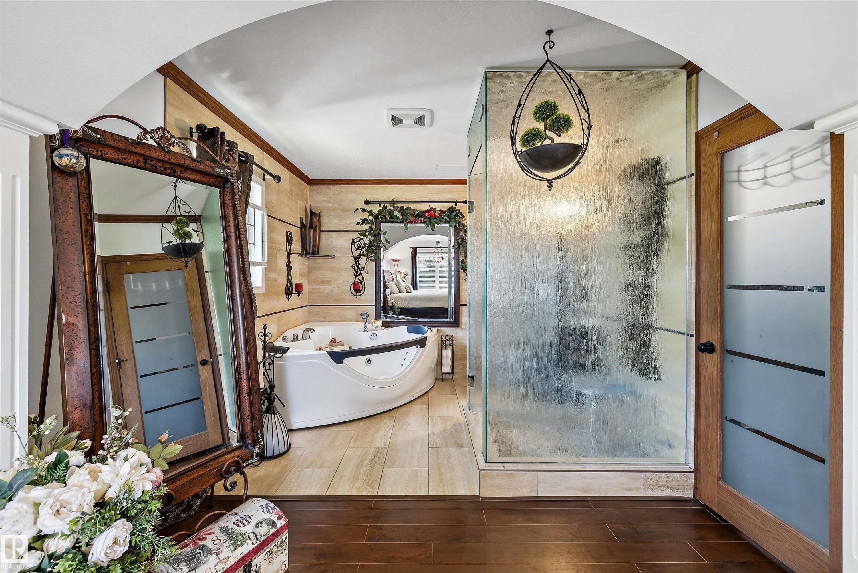 Expansive bathroom featuring a corner jetted soaking tub, a stand-alone shower with obscured glass walls, and tile flooring - 11124 110A Avenue Nw, Edmonton, AB