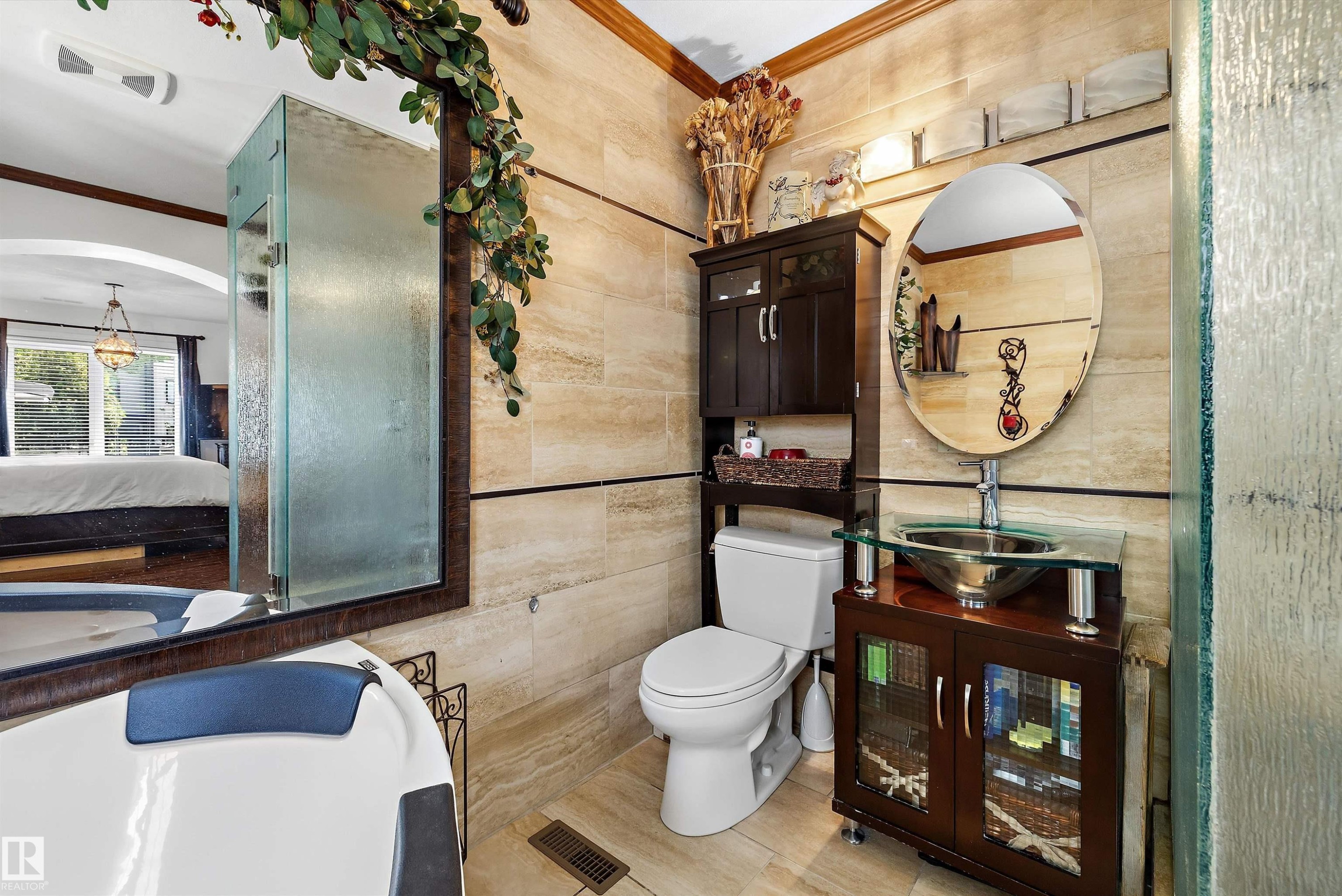 Bathroom featuring floor-to-ceiling tiled walls, a glass vessel sink, and a modern vanity with integrated storage - 11124 110A Avenue Nw, Edmonton, AB
