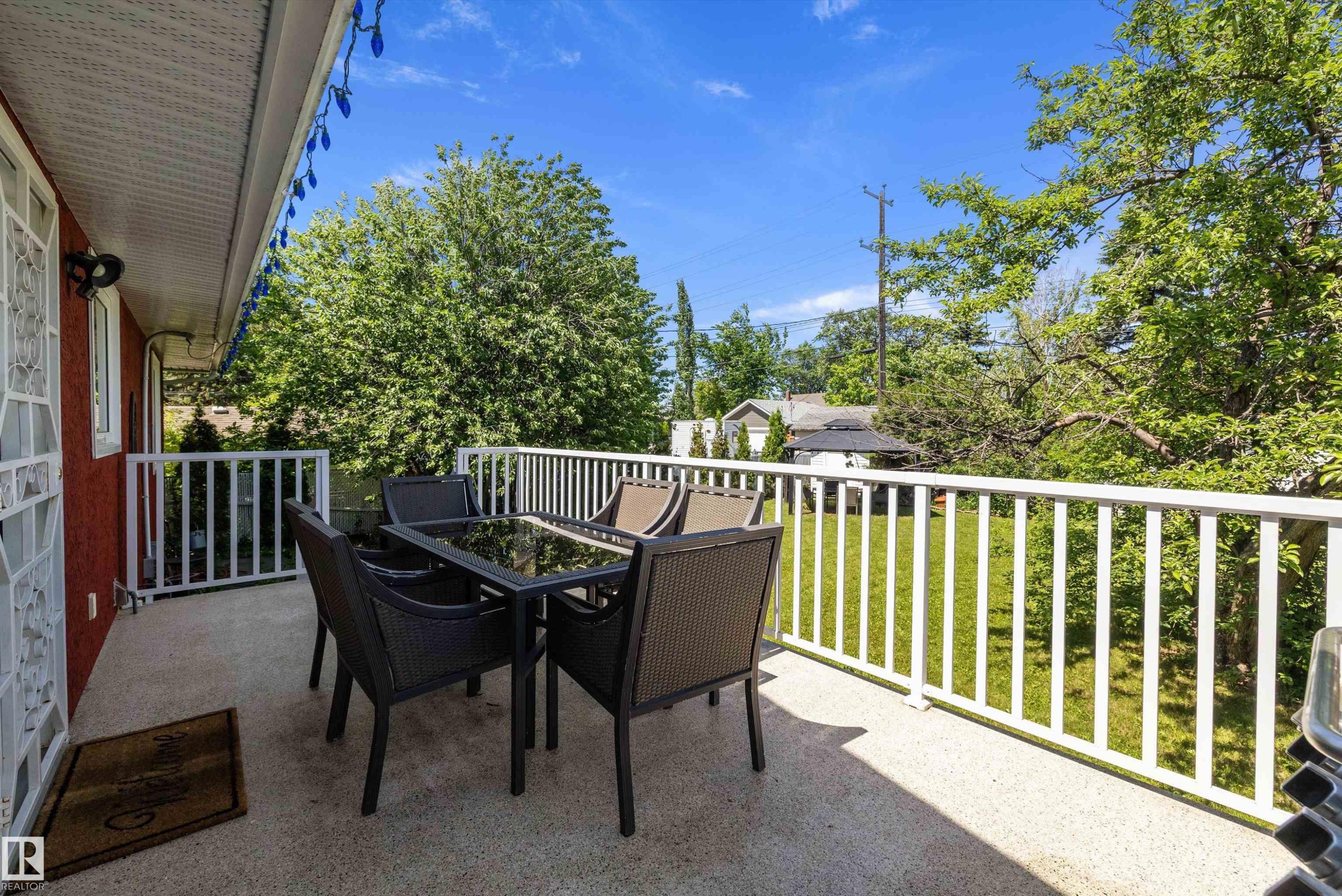 Expansive outdoor balcony featuring a textured concrete surface and white slatted railing - 11124 110A Avenue Nw, Edmonton, AB