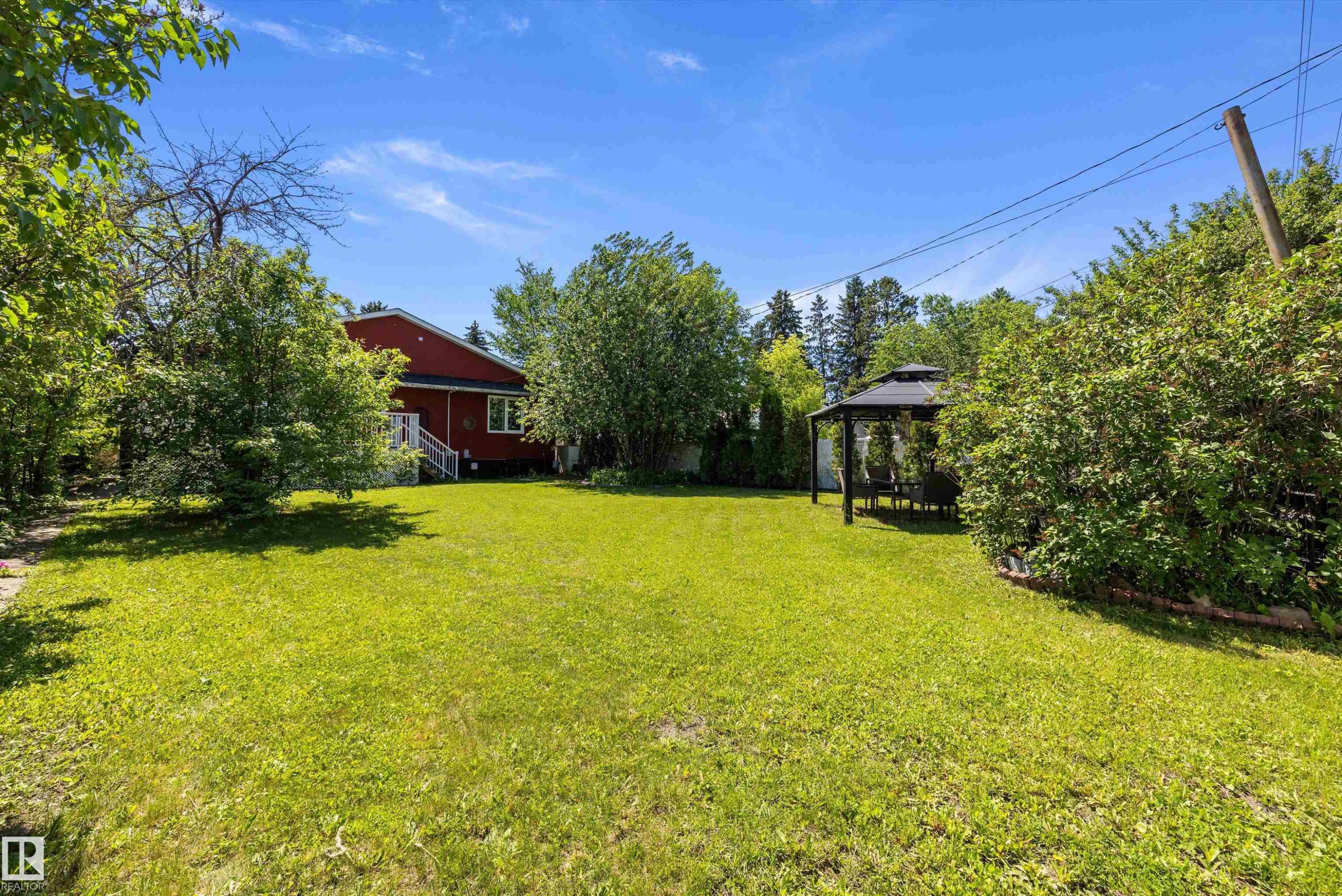 Expansive green lawn with a dark metal gazebo - 11124 110A Avenue Nw, Edmonton, AB