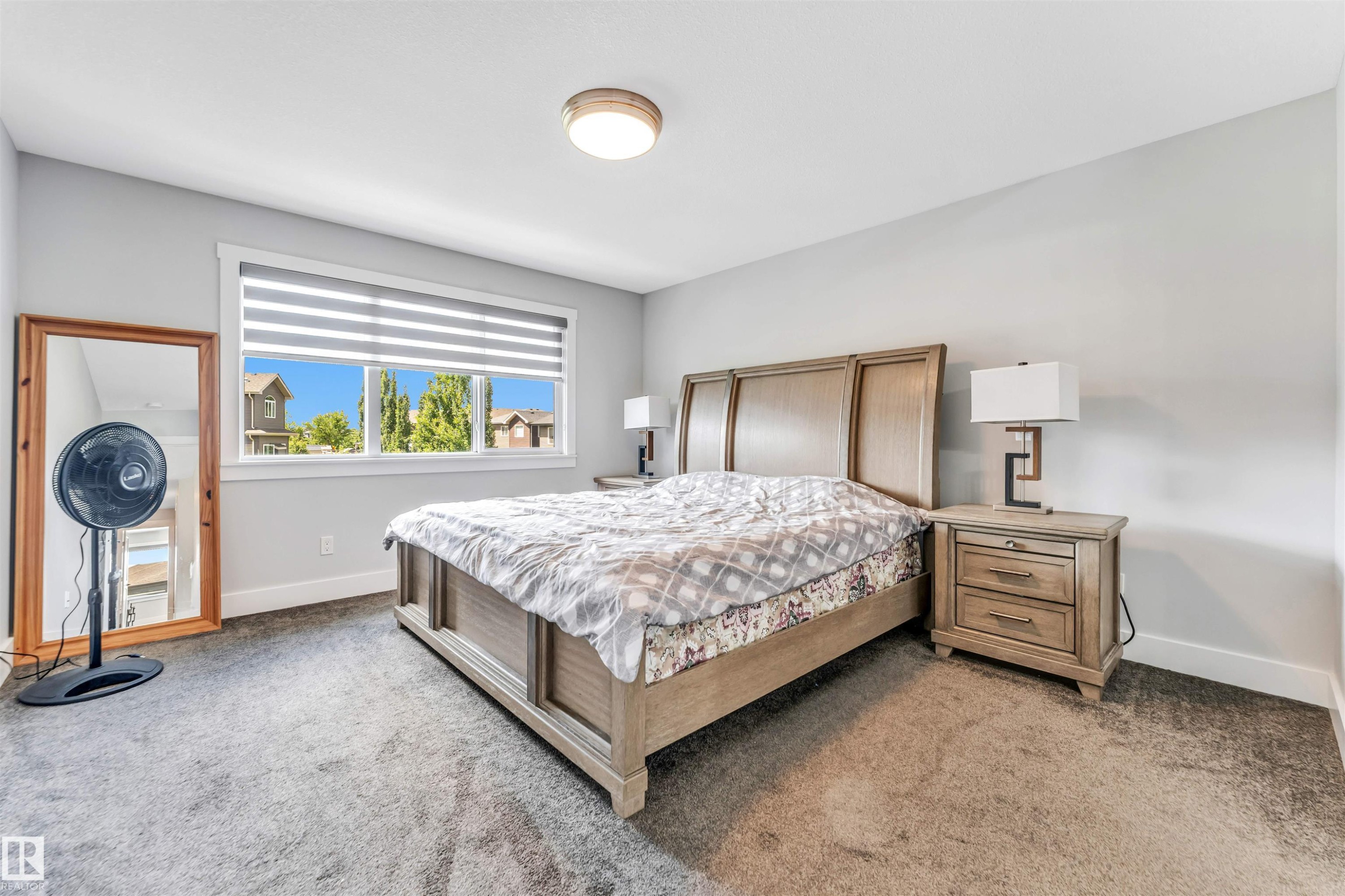 Bright bedroom with neutral wall tones and dark carpet flooring - 8516 216 Street, Edmonton, AB