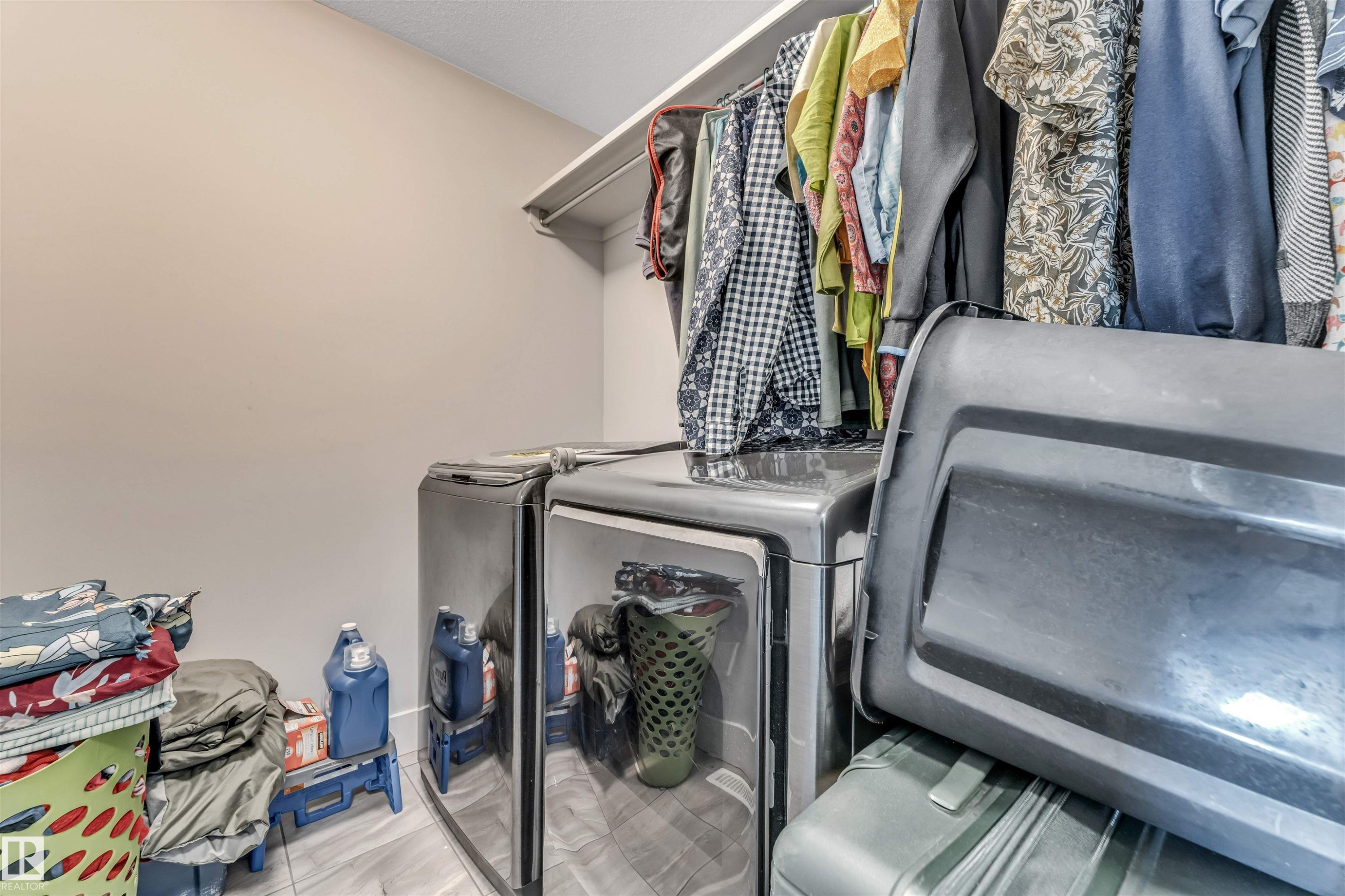 Laundry area featuring light-toned walls and wood-finish flooring - 8516 216 Street, Edmonton, AB