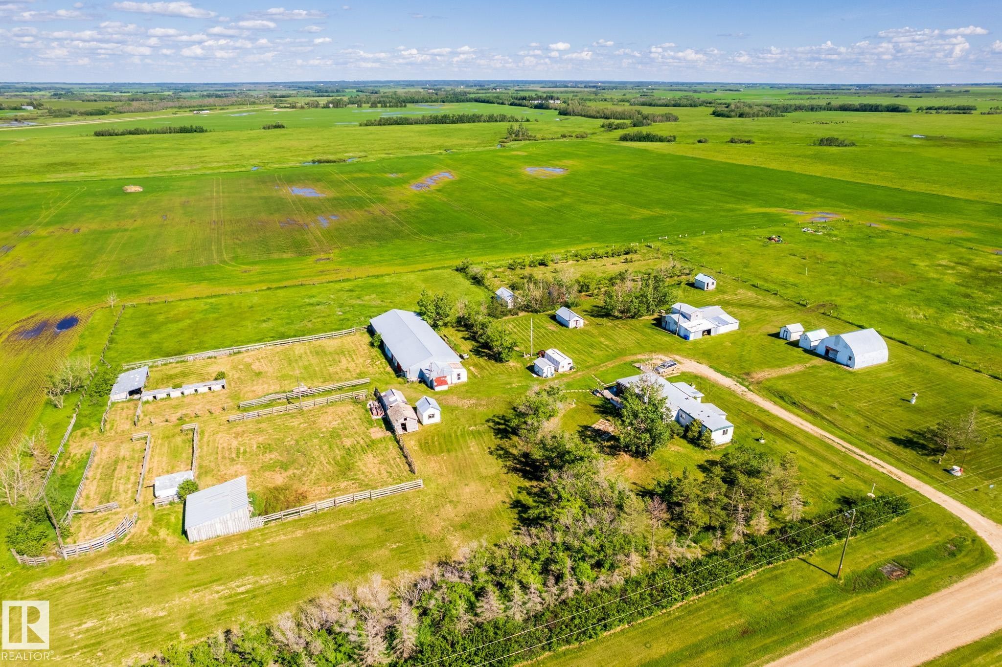 Expansive agricultural property featuring multiple outbuildings, fenced enclosures, a primary residence, and a long driveway - 551027 Range Road 193, Rural Lamont County, AB