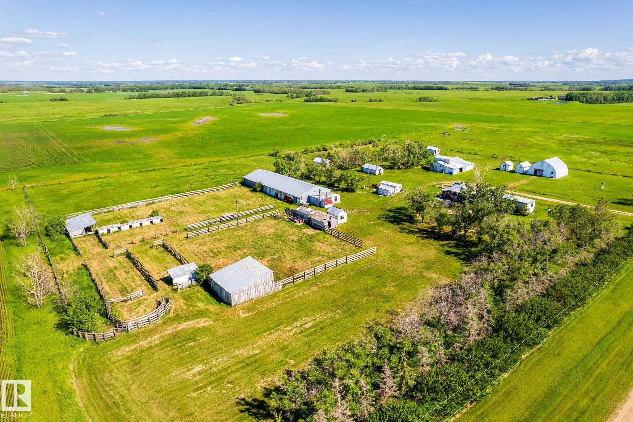 Expansive rural property featuring multiple outbuildings, fenced enclosures, open fields, and scattered trees - 551027 Range Road 193, Rural Lamont County, AB