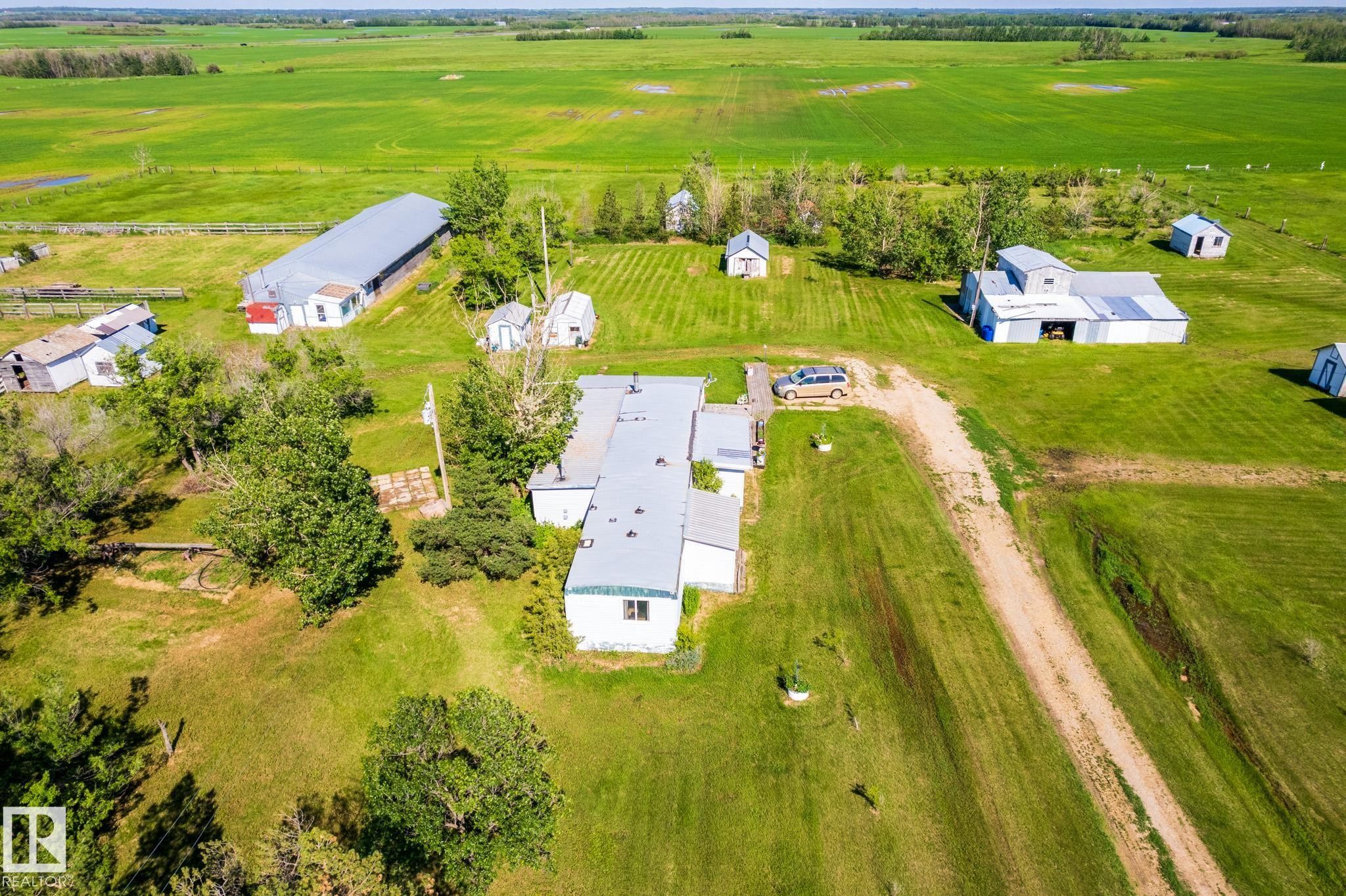Expansive property featuring multiple outbuildings, a main residence, and vast green fields - 551027 Range Road 193, Rural Lamont County, AB