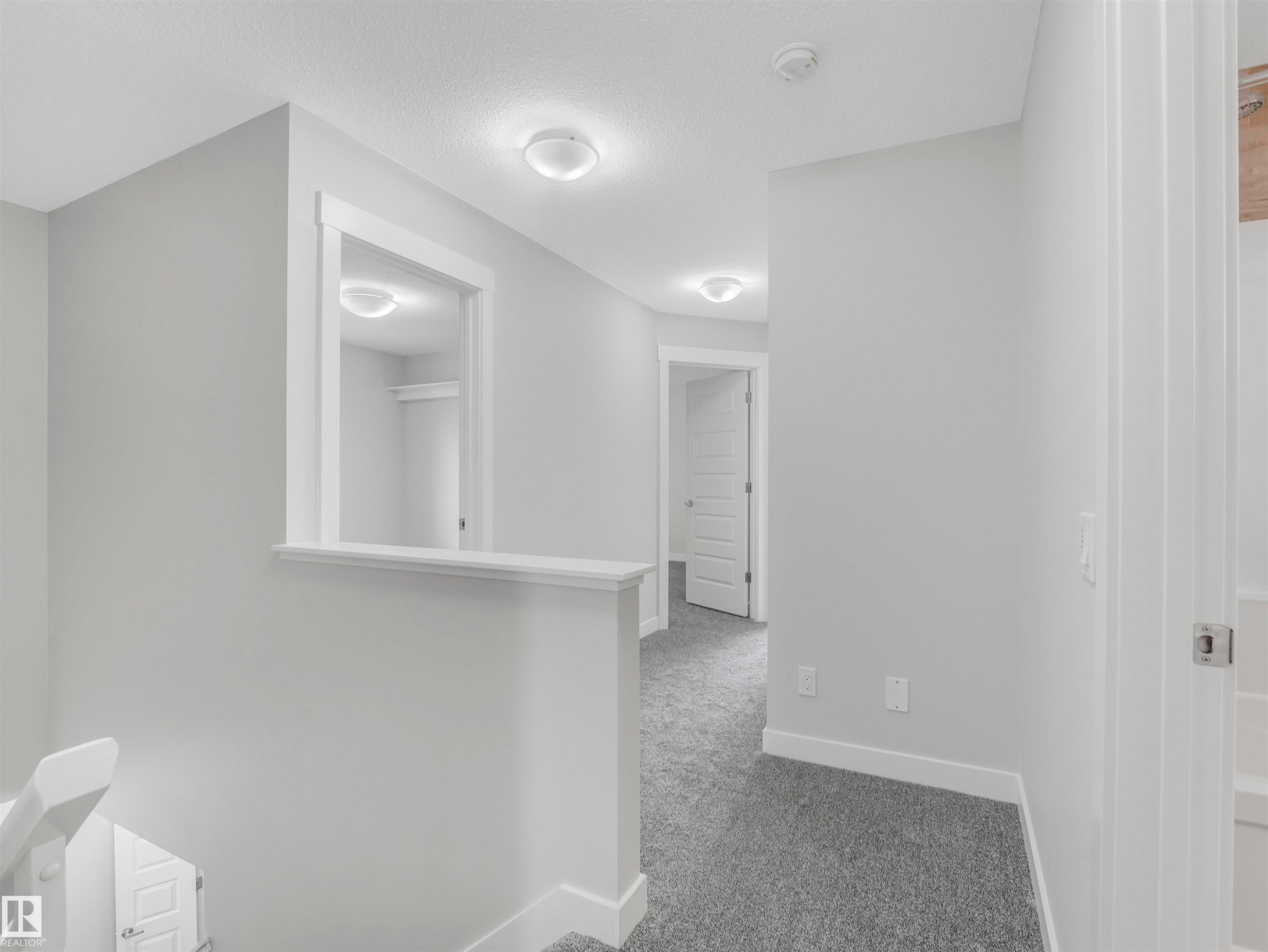 Hallway featuring light gray walls, white trim, recessed lighting, and gray carpet flooring - 20507 99 Avenue, Edmonton, AB - Indoor Photo Showing Other Room