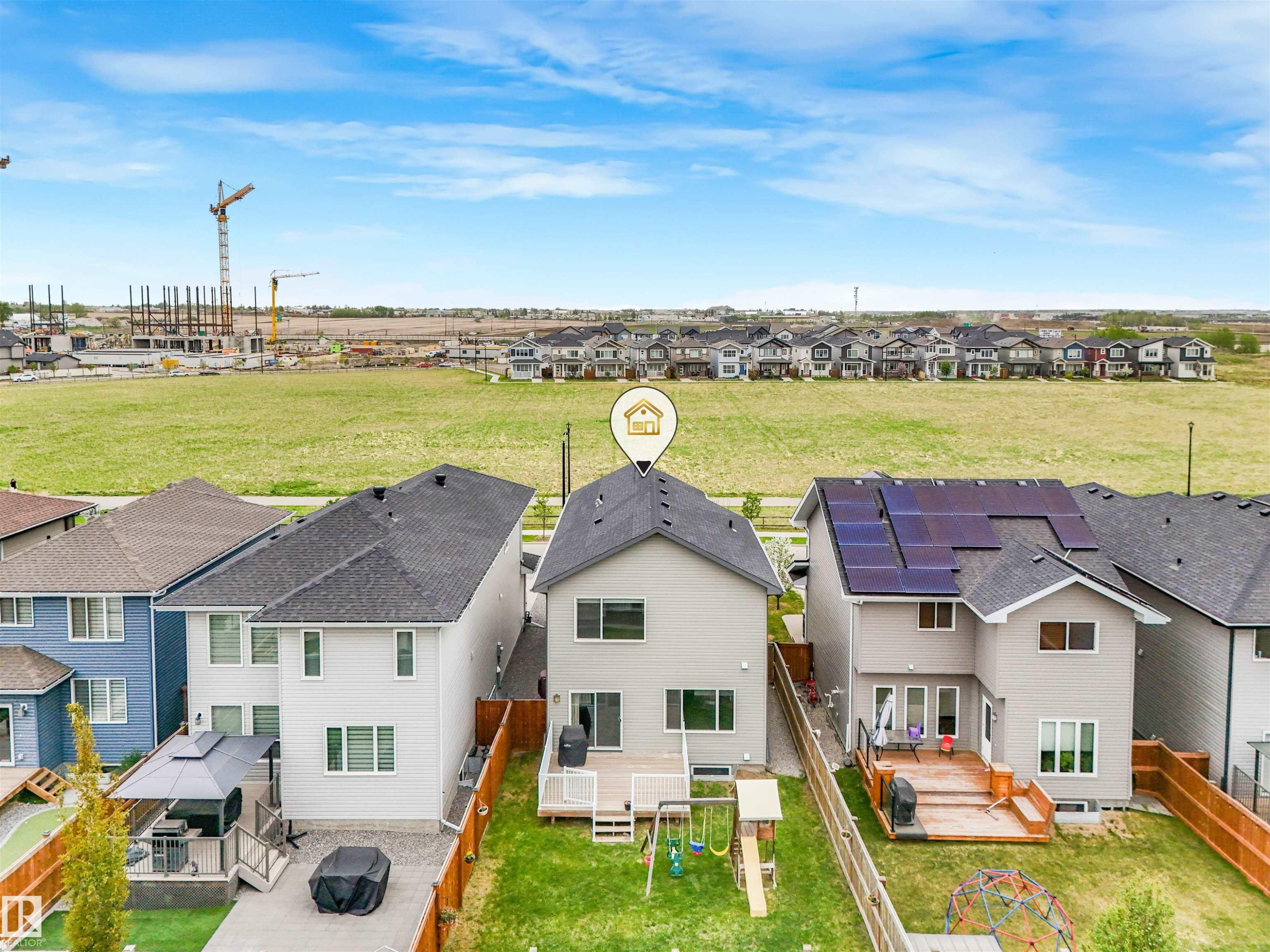 Rear exterior with a wood deck, a fenced yard, and a visible construction area - 20507 99 Avenue, Edmonton, AB - Outdoor