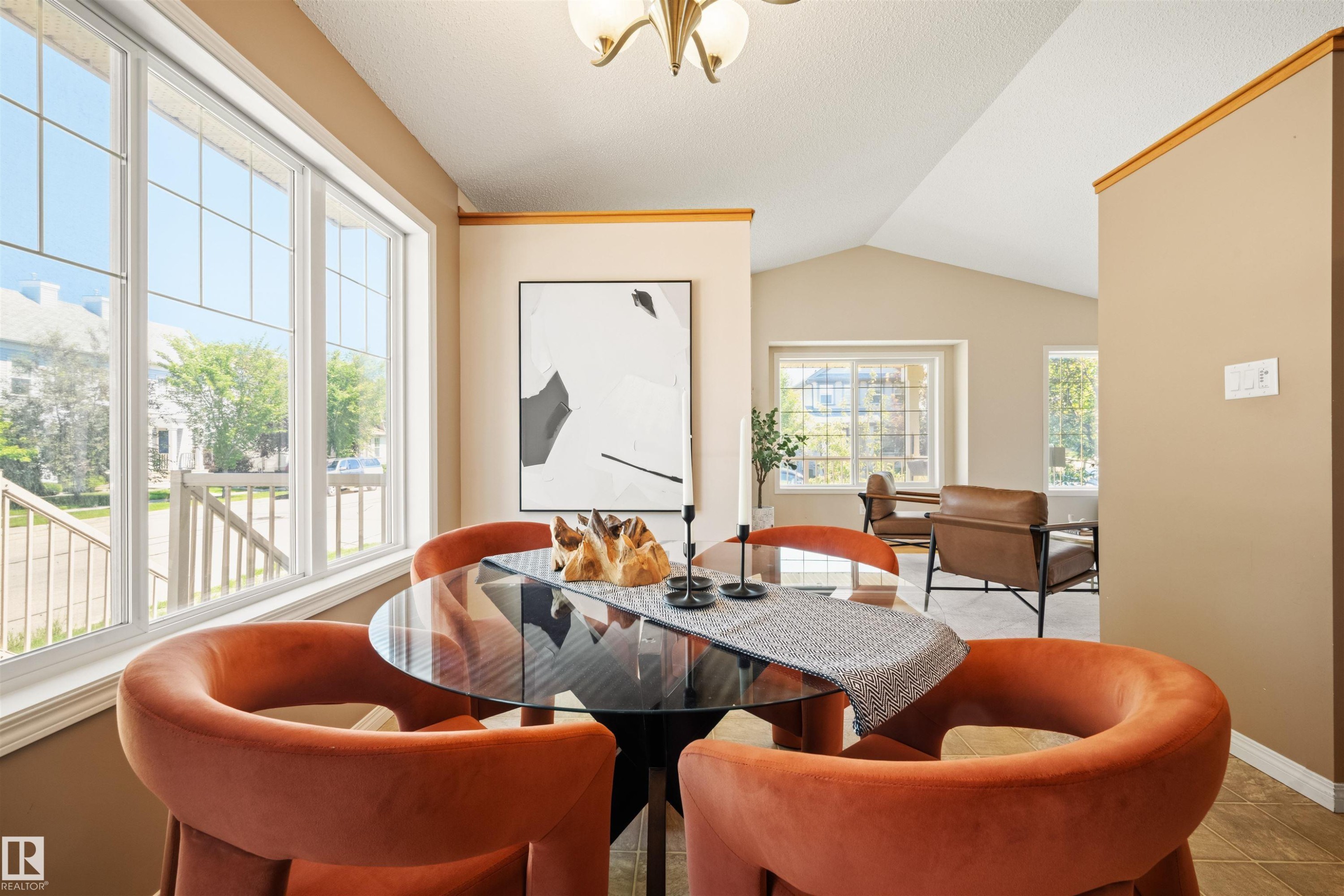 Dining area featuring a large multi-pane window, vaulted ceiling, and neutral wall tones - 7838 Schmid Place Nw, Edmonton, AB - Indoor