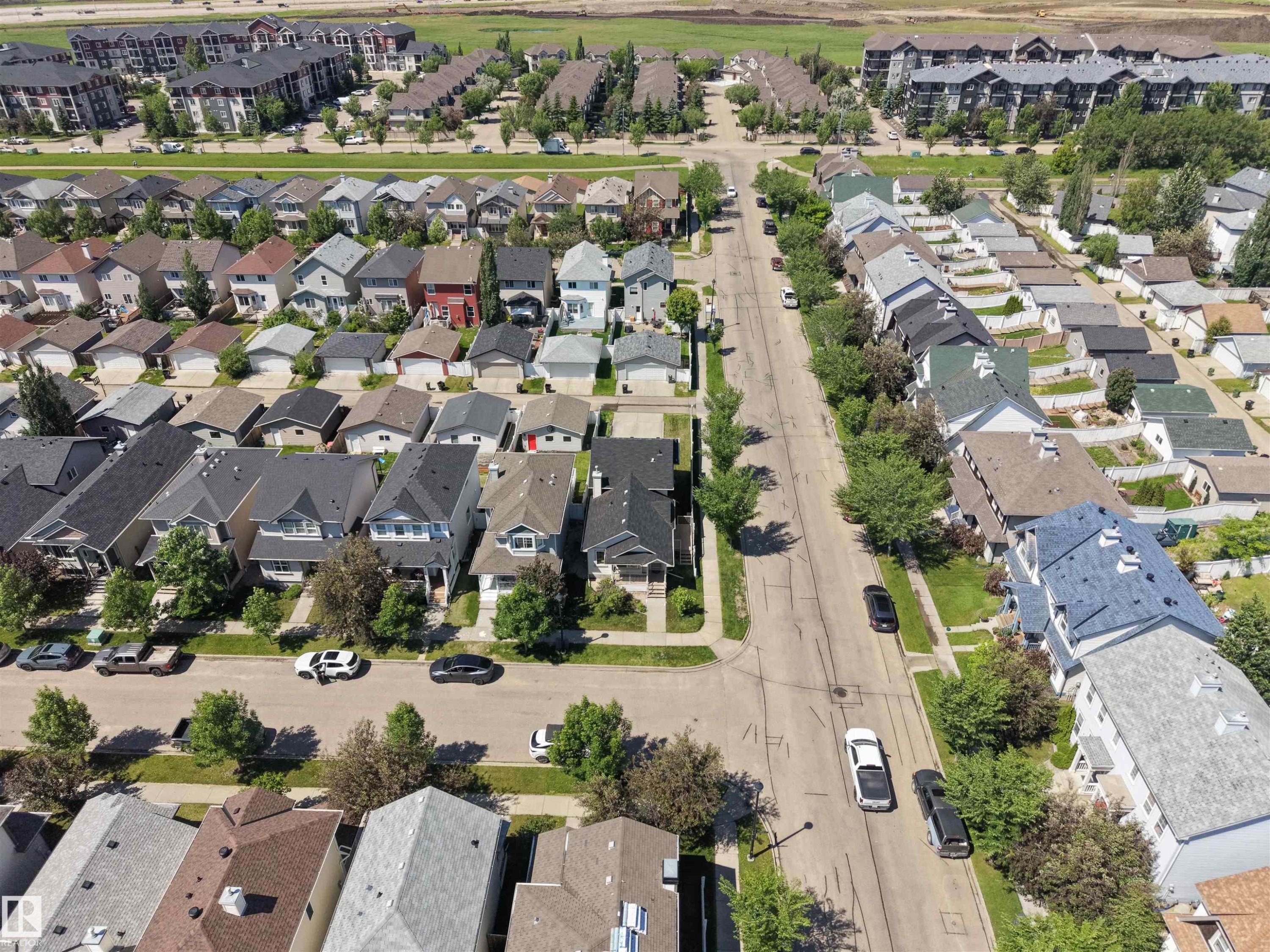 Residential street with established homes featuring varied architectural styles and pitched roofs - 7838 Schmid Place Nw, Edmonton, AB - Outdoor With View