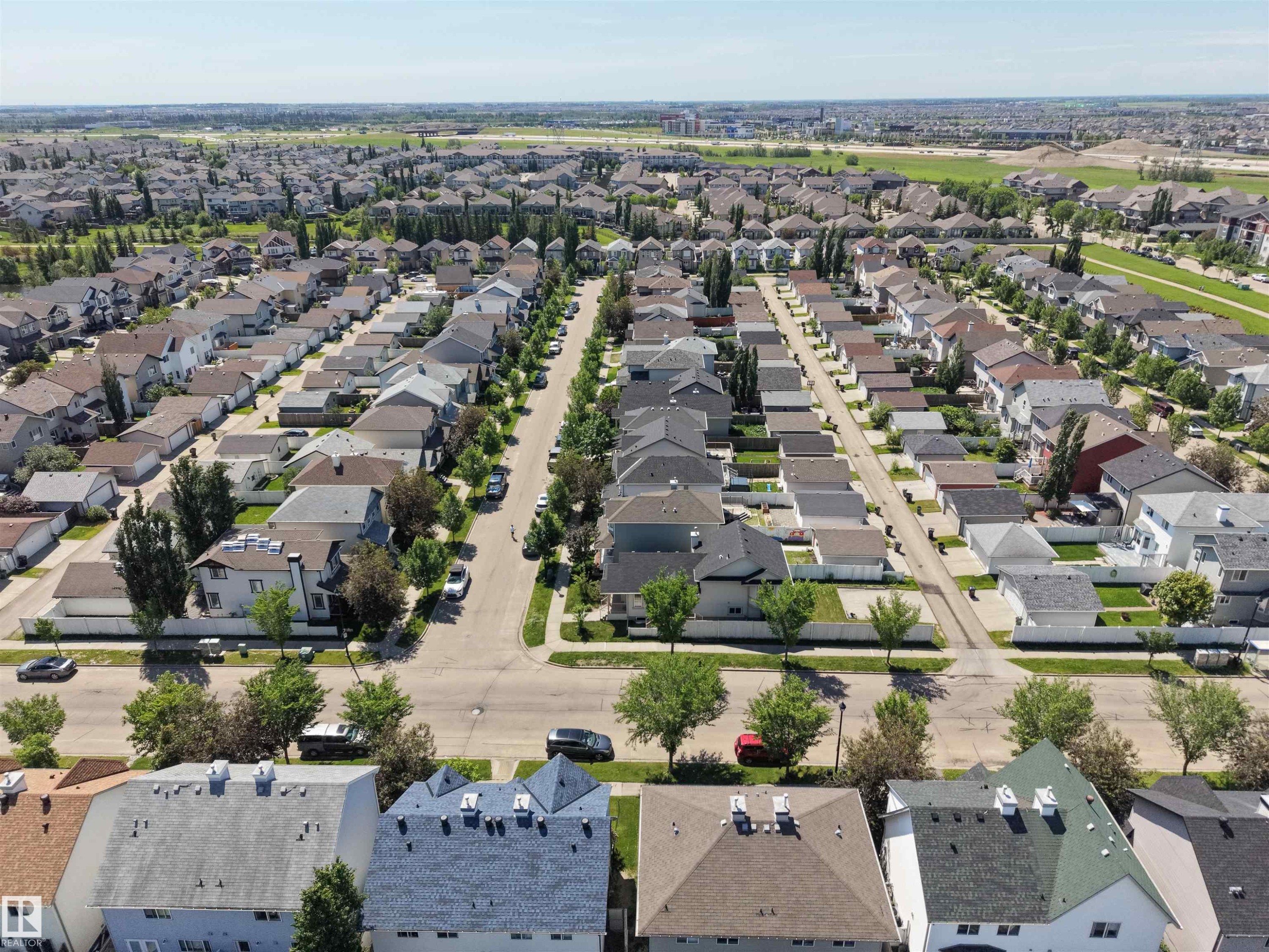 Expansive residential development featuring numerous single-family homes with pitched roofs and varied exterior finishes - 7838 Schmid Place Nw, Edmonton, AB - Outdoor With View