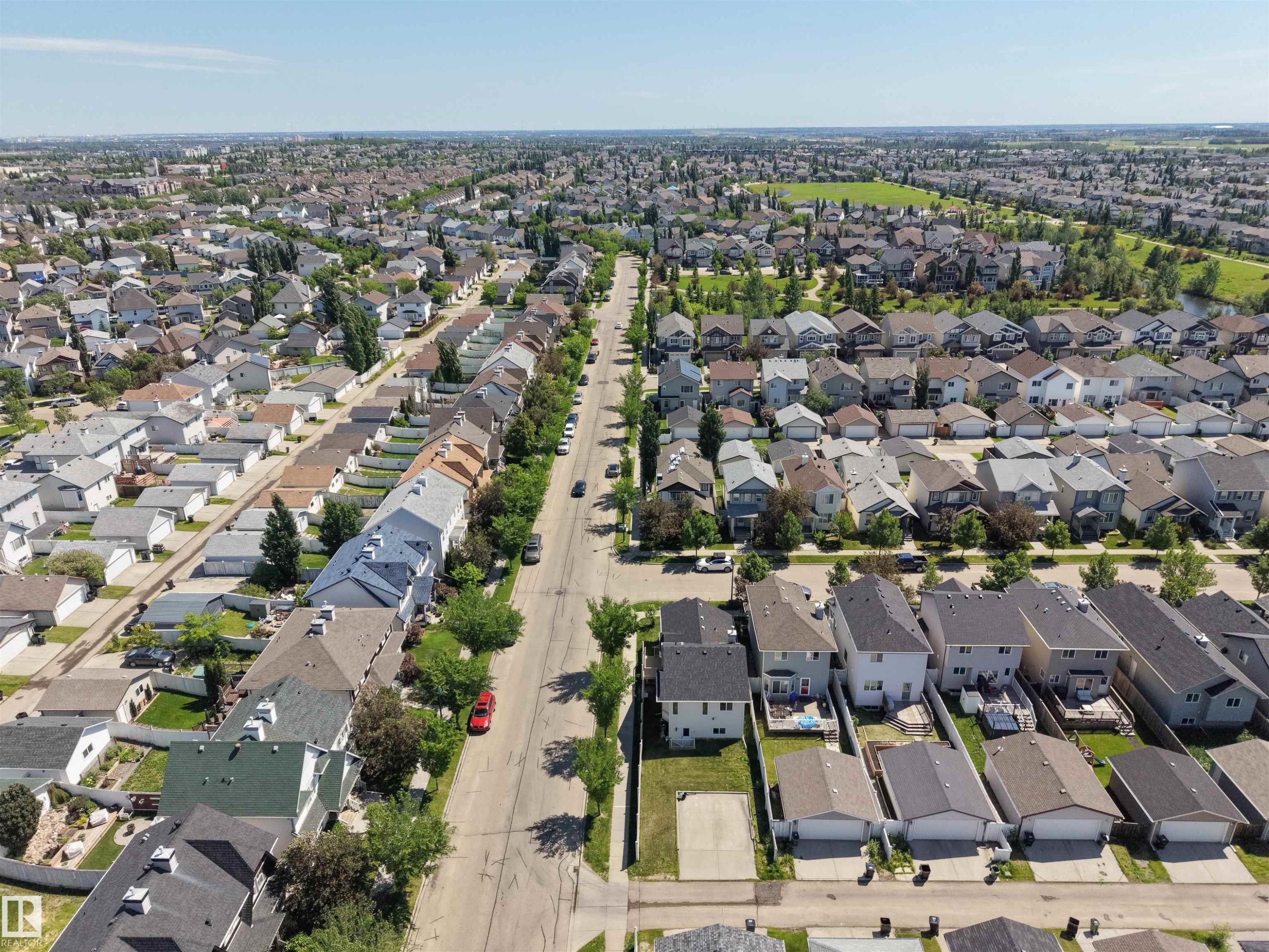 Aerial perspective showcasing a residential community with numerous detached properties - 7838 Schmid Place Nw, Edmonton, AB - Outdoor With View