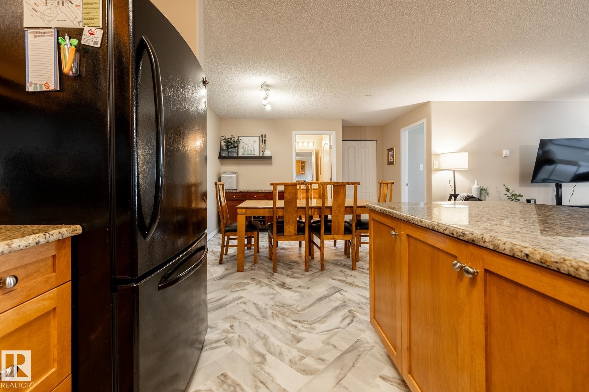 Kitchen counter with a granite-style surface - 330 1520 Hammond Gate Gate, Edmonton, AB