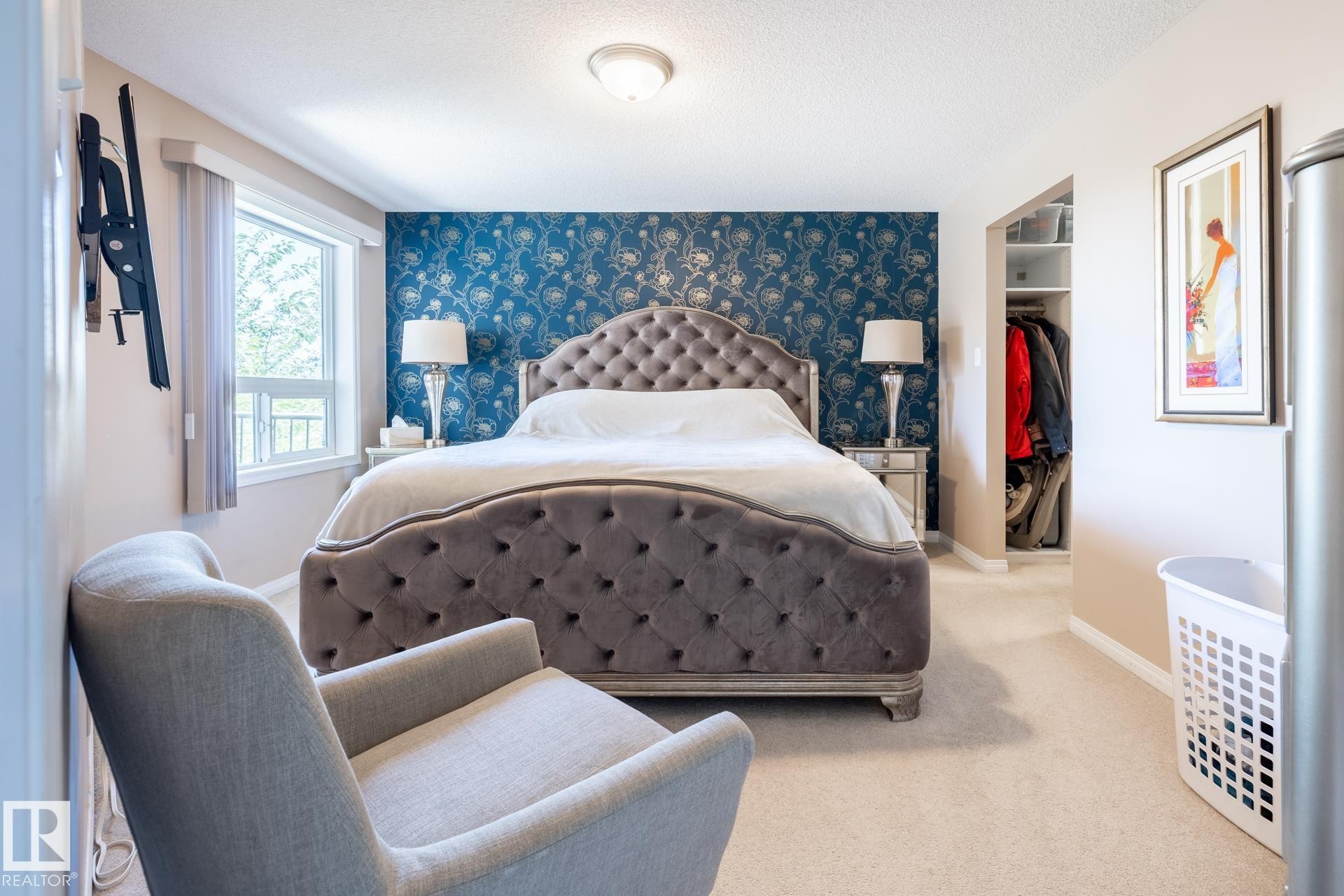 Bedroom featuring a window with a white frame, carpet flooring, and a built-in closet with shelving - 330 1520 Hammond Gate Gate, Edmonton, AB