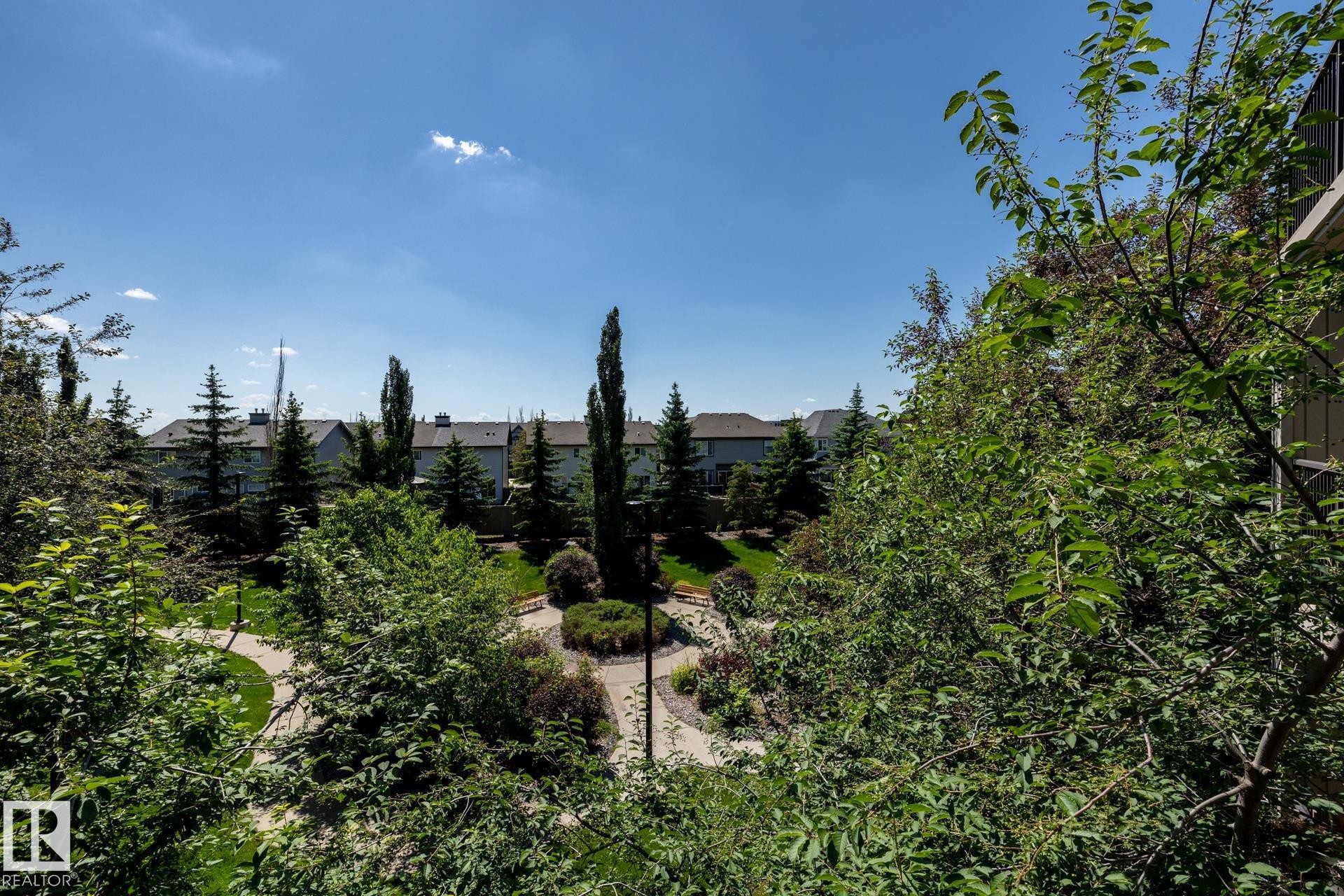 Lush green landscaping with mature trees and paved walking paths - 330 1520 Hammond Gate Gate, Edmonton, AB