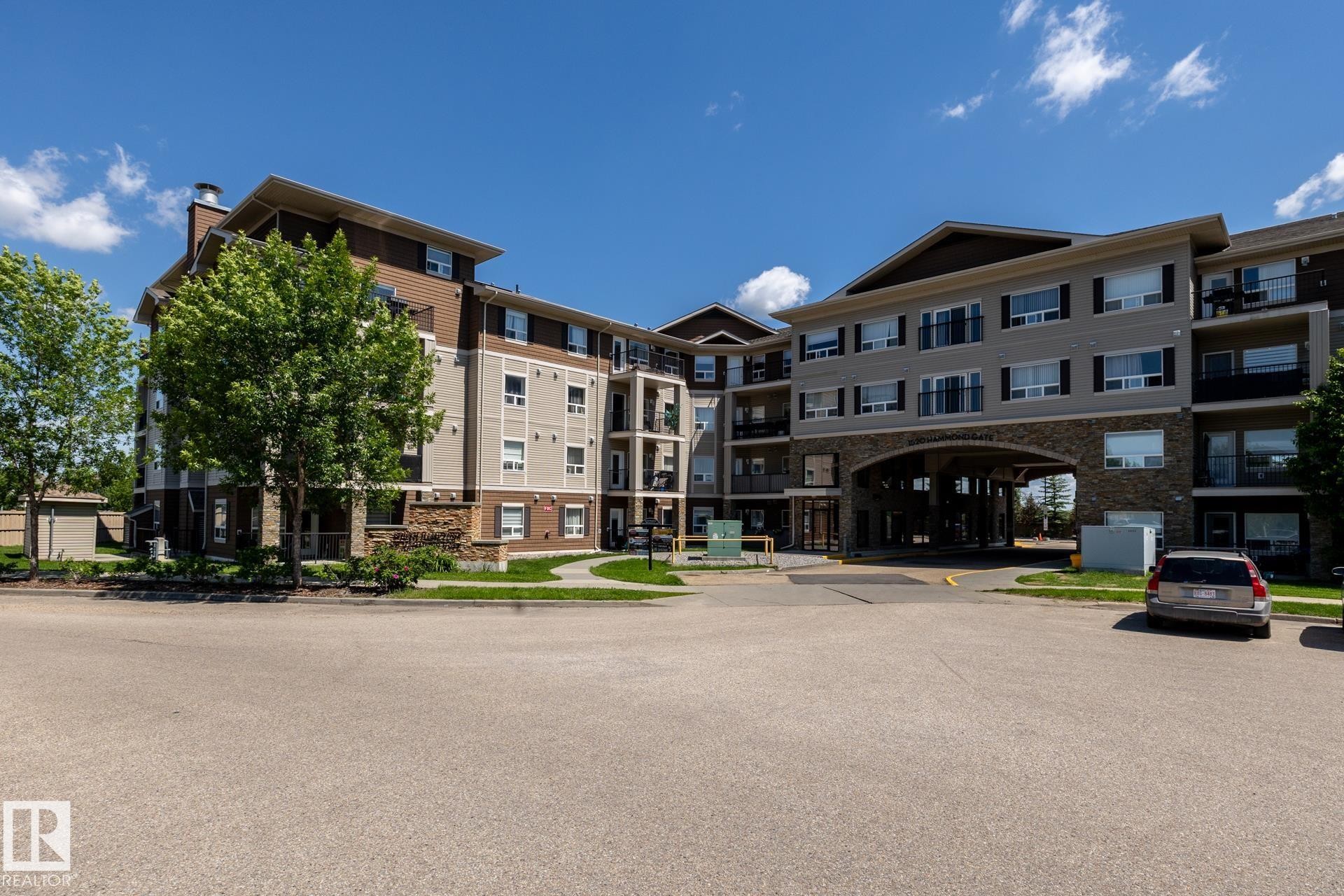 Contemporary multi-story building featuring stone veneer and horizontal siding accents - 330 1520 Hammond Gate Gate, Edmonton, AB