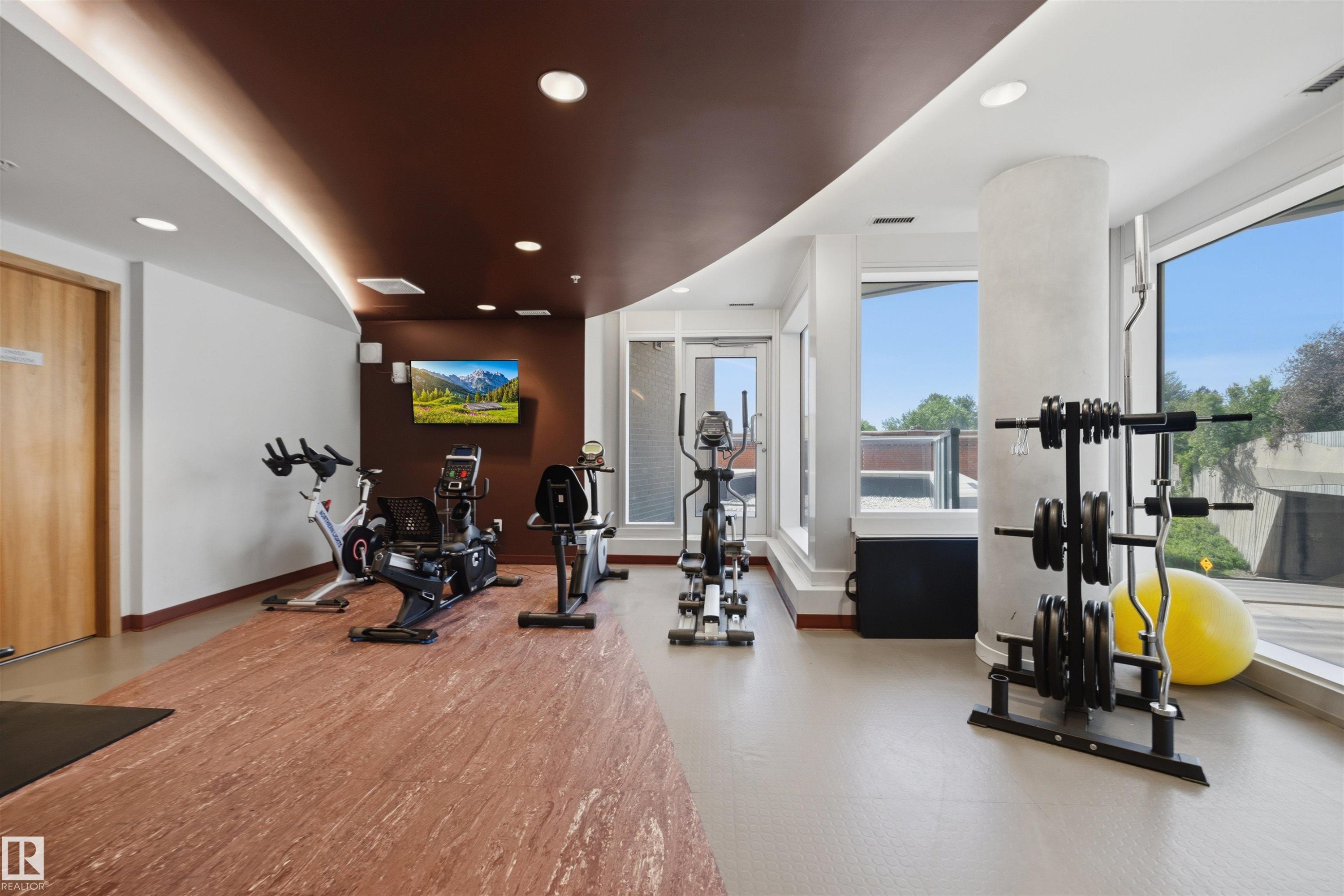 Interior fitness area featuring a brown accent ceiling with recessed lighting - #802 9720 106 St Nw, Edmonton, AB - Indoor Photo Showing Gym Room