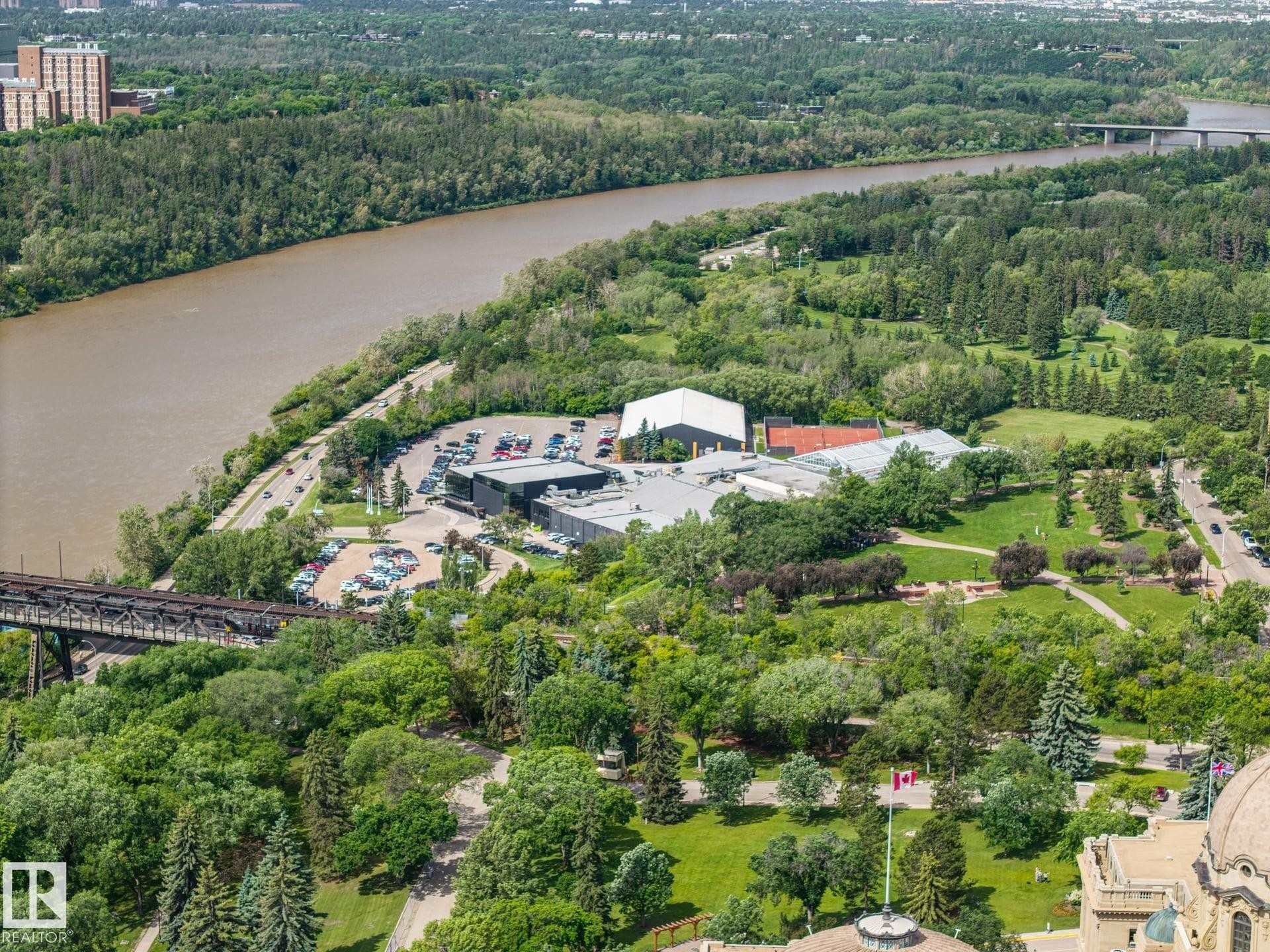 Aerial perspective showcasing a large river, expansive green spaces, and a commercial complex - #802 9720 106 St Nw, Edmonton, AB - Outdoor With View