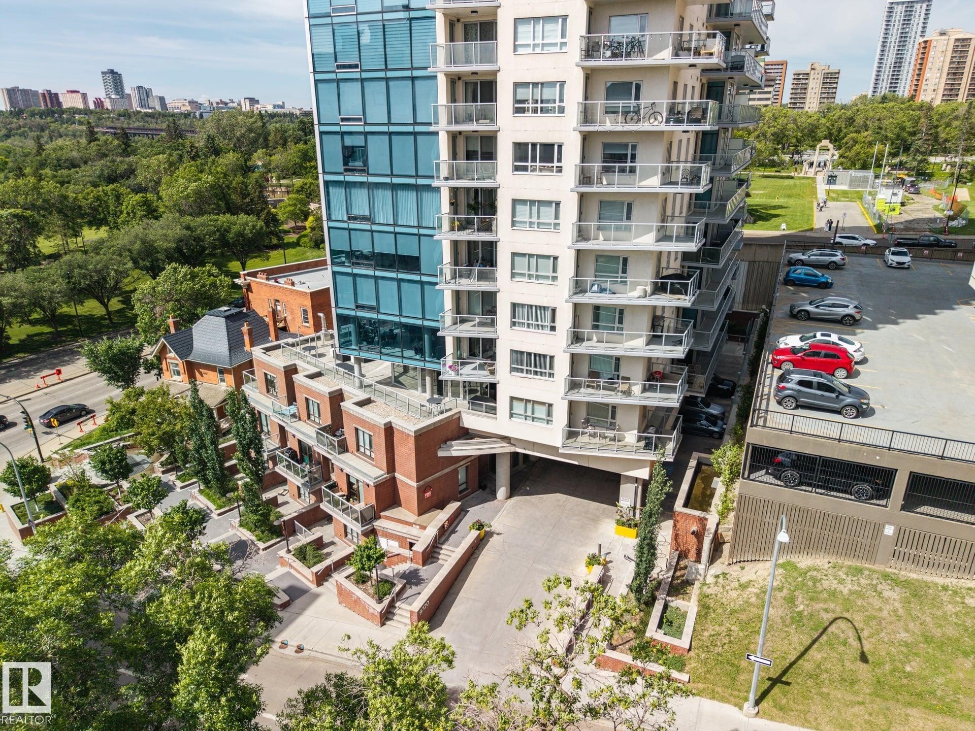 Contemporary high-rise building featuring a glass facade and individual balconies - #802 9720 106 St Nw, Edmonton, AB - Outdoor With Balcony
