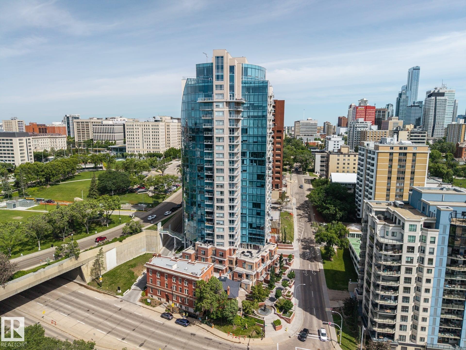 Modern high-rise with a curved glass facade and multiple balconies - #802 9720 106 St Nw, Edmonton, AB - Outdoor