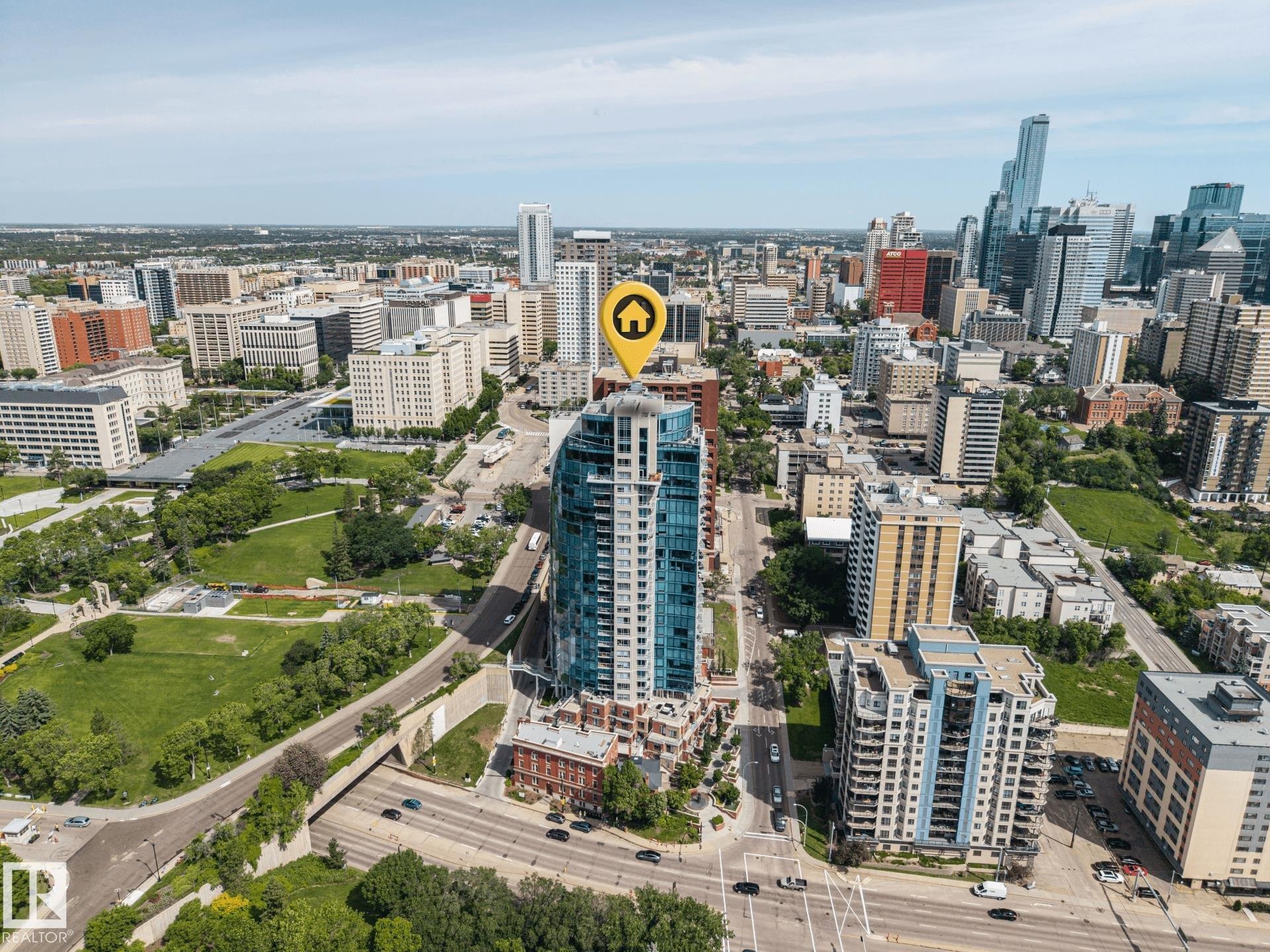 High-rise residential building with a curved glass facade and extensive fenestration - #802 9720 106 St Nw, Edmonton, AB - Outdoor With View