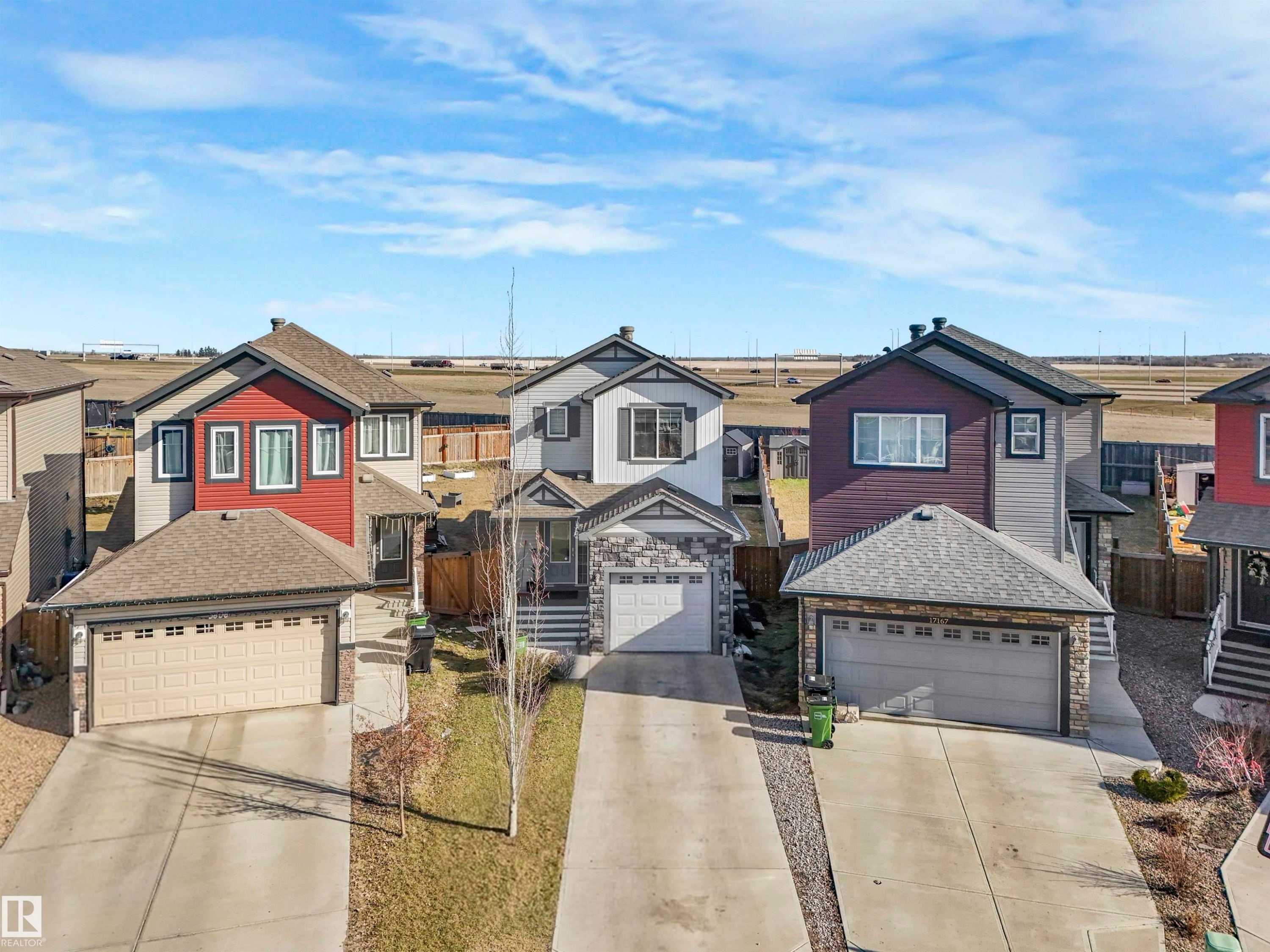 Modern architectural design featuring varied siding materials and a prominent two-car garage - 17171 38 Street, Edmonton, AB