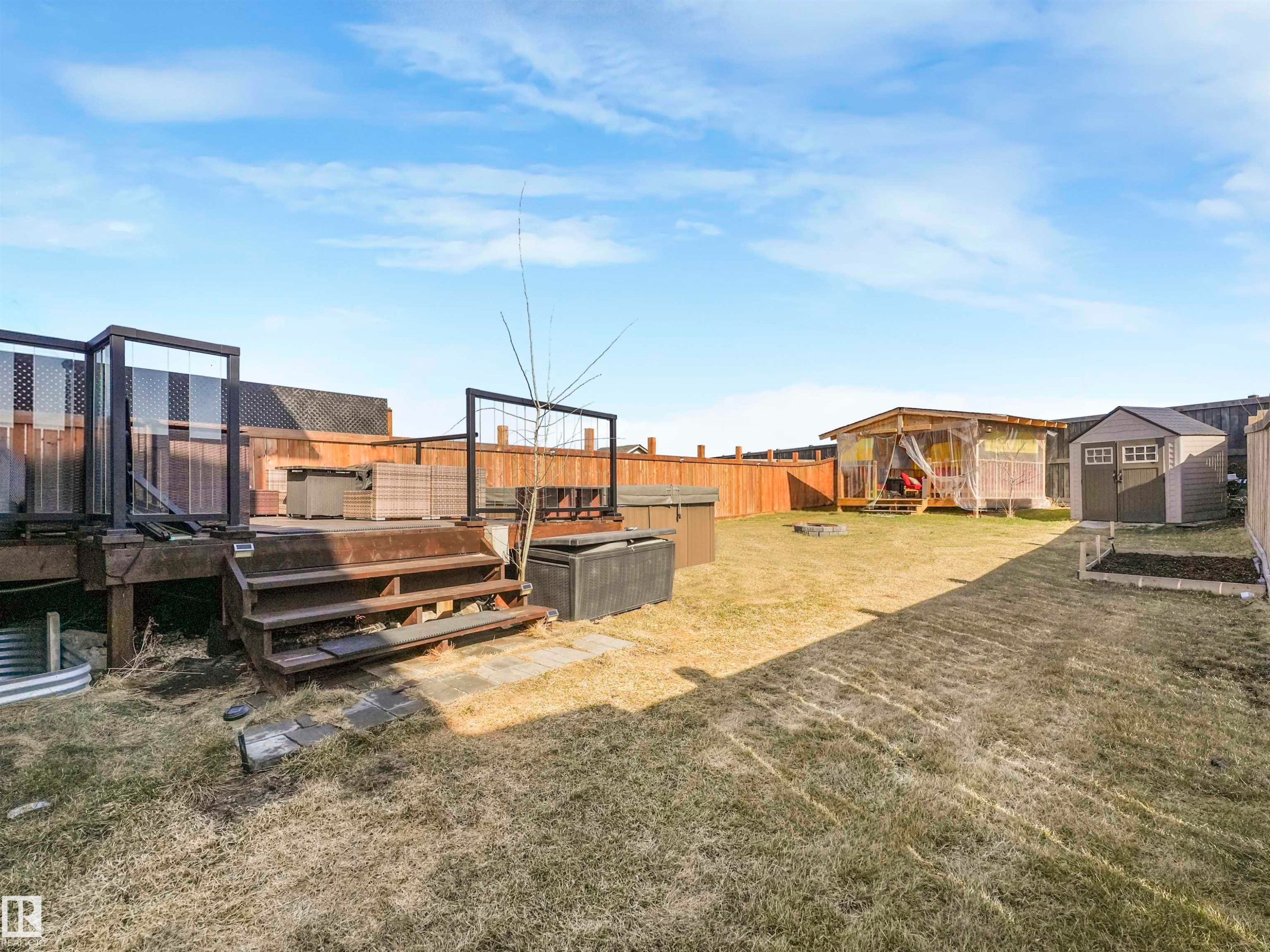 Spacious backyard featuring a multi-level deck, a gazebo, and a storage shed - 17171 38 Street, Edmonton, AB