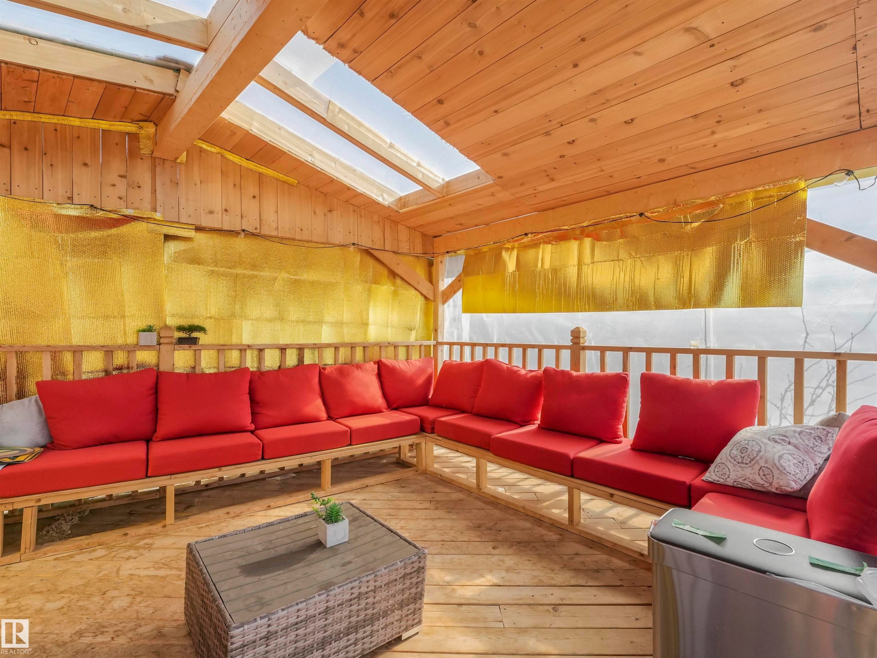 Covered outdoor space featuring natural wood plank flooring and ceiling - 17171 38 Street, Edmonton, AB