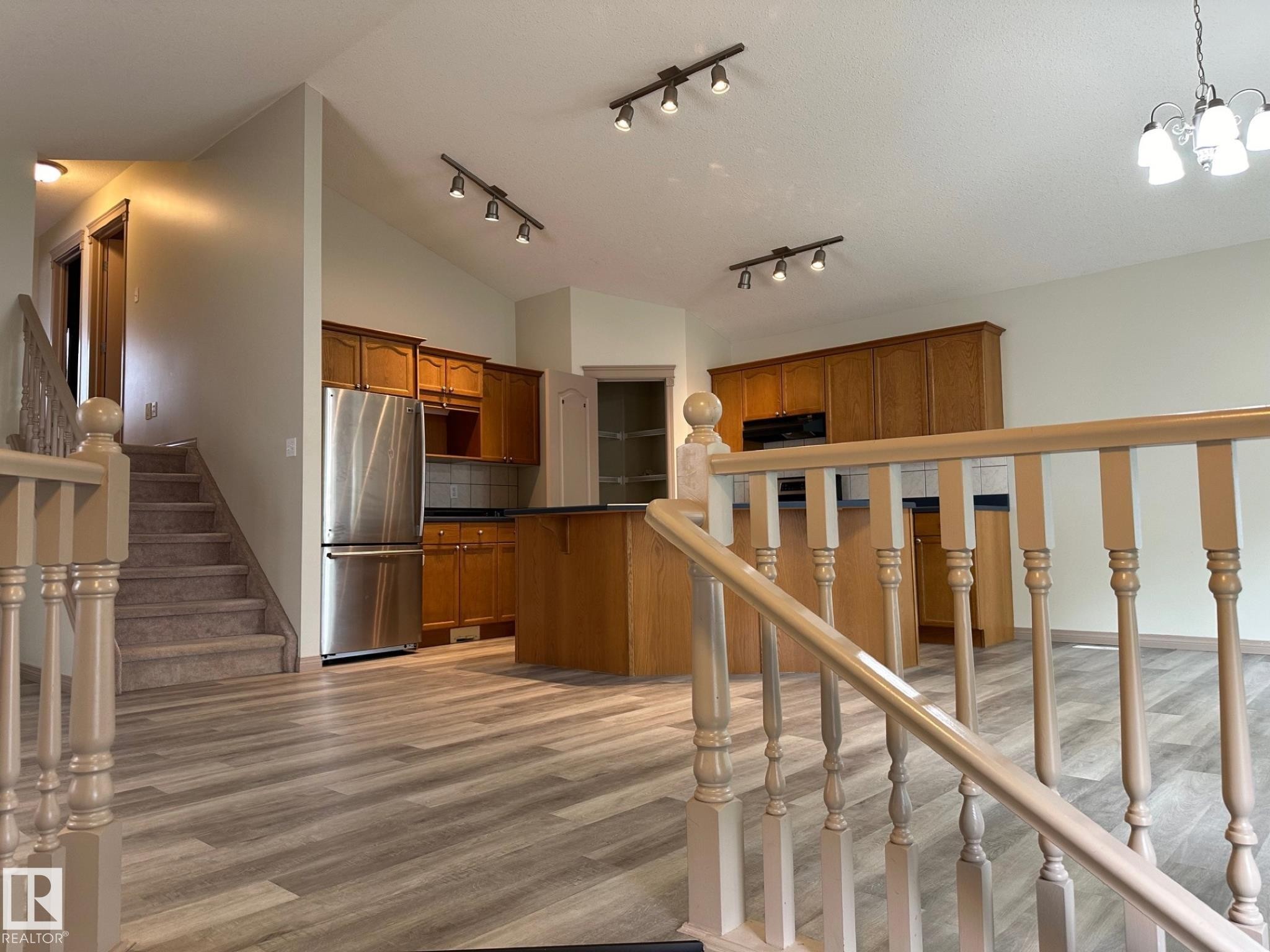Open-concept living space with wood-finish flooring - 1978 Tomlinson Green Green, Edmonton, AB