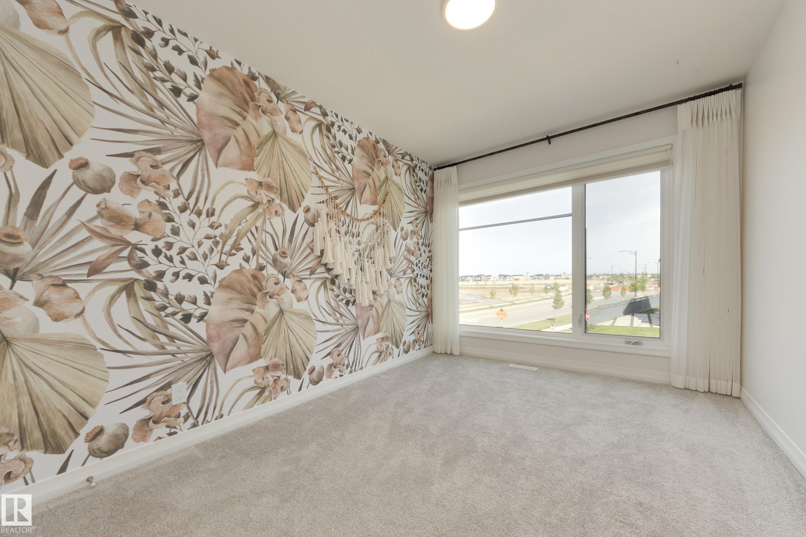Accent wall featuring botanical-patterned wallpaper - 3249 Dixon Way Sw, Edmonton, AB