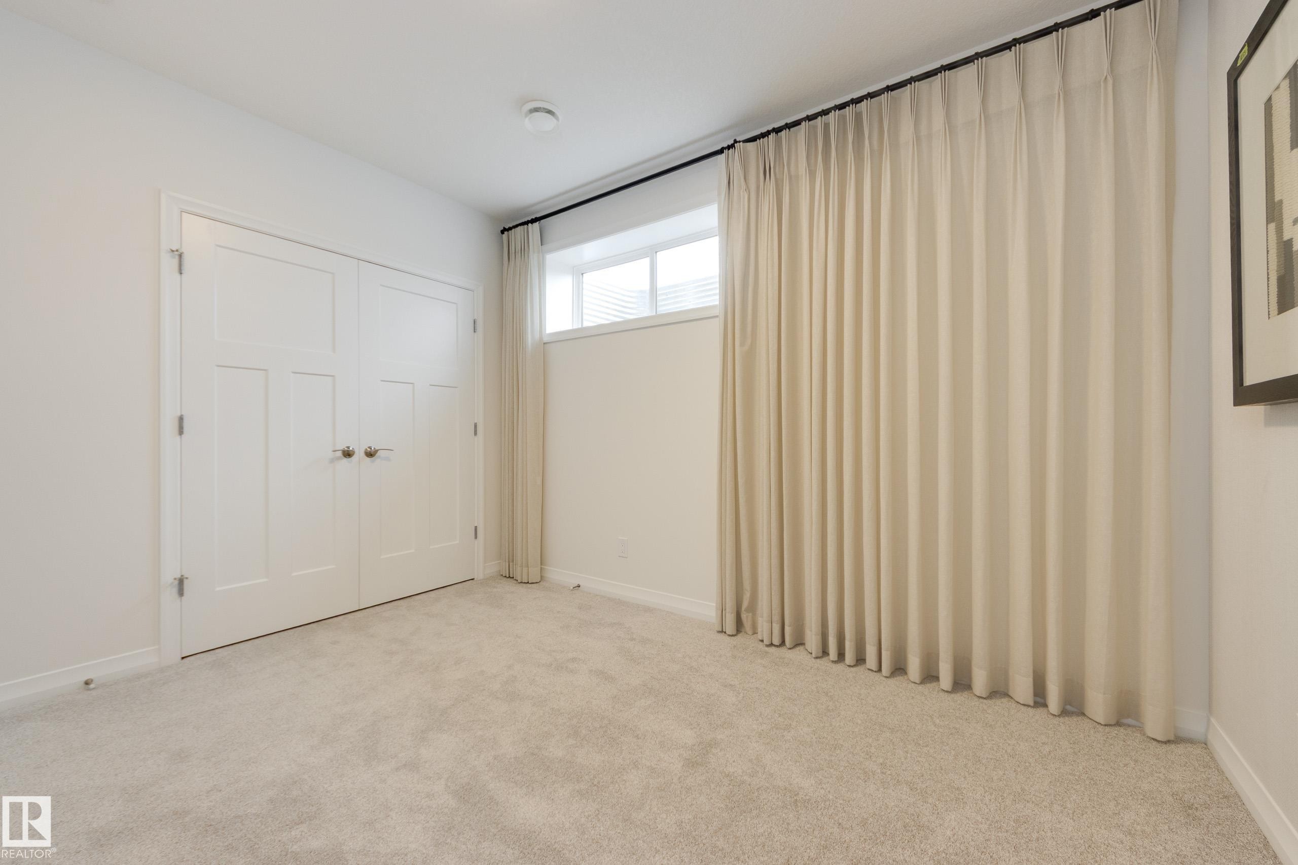 Light-colored wall-to-wall carpeting throughout - 3249 Dixon Way Sw, Edmonton, AB