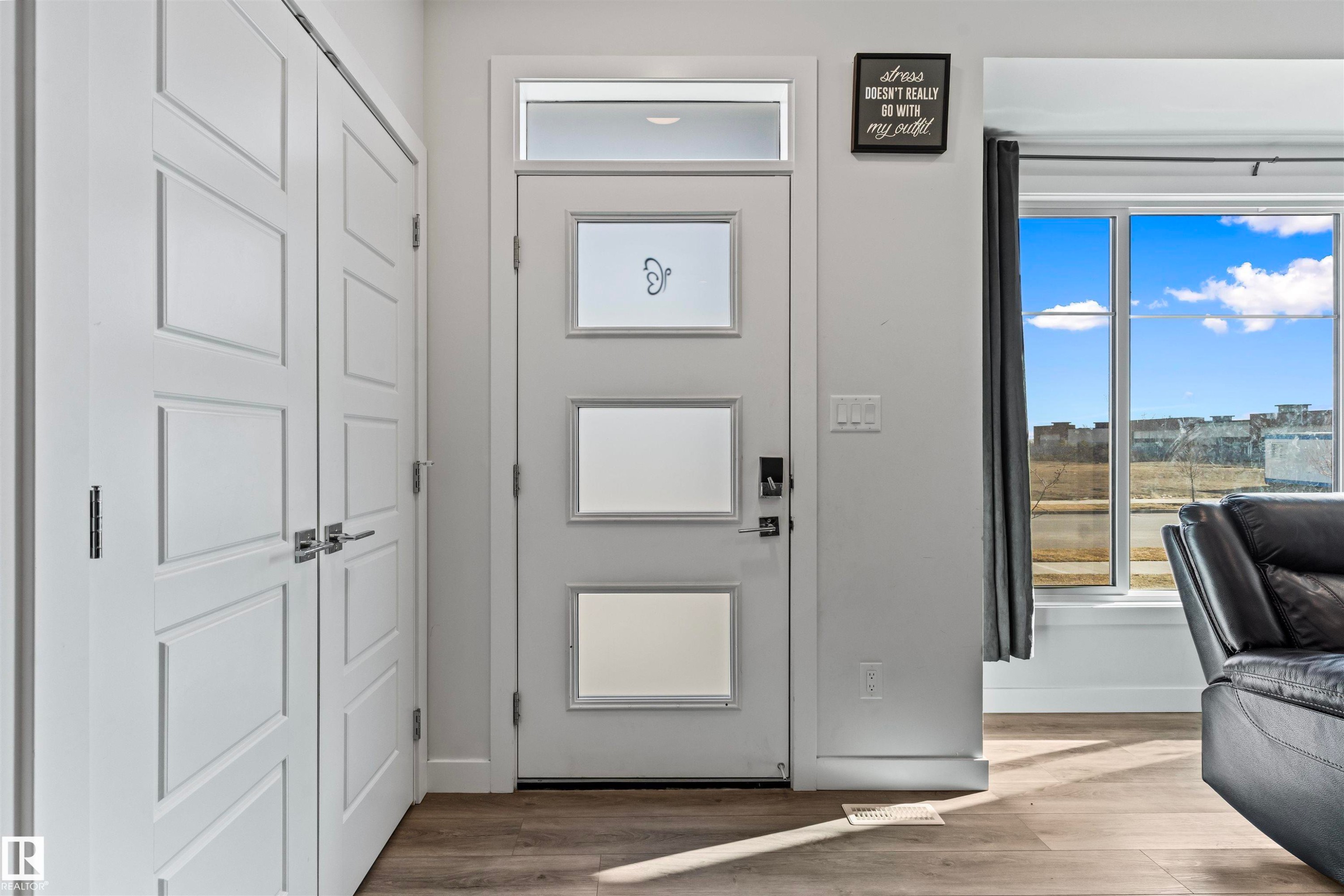 Entryway featuring a modern door with rectangular frosted glass panels and a transom window - 8046 Kiriak Link, Edmonton, AB - Indoor Photo Showing Other Room