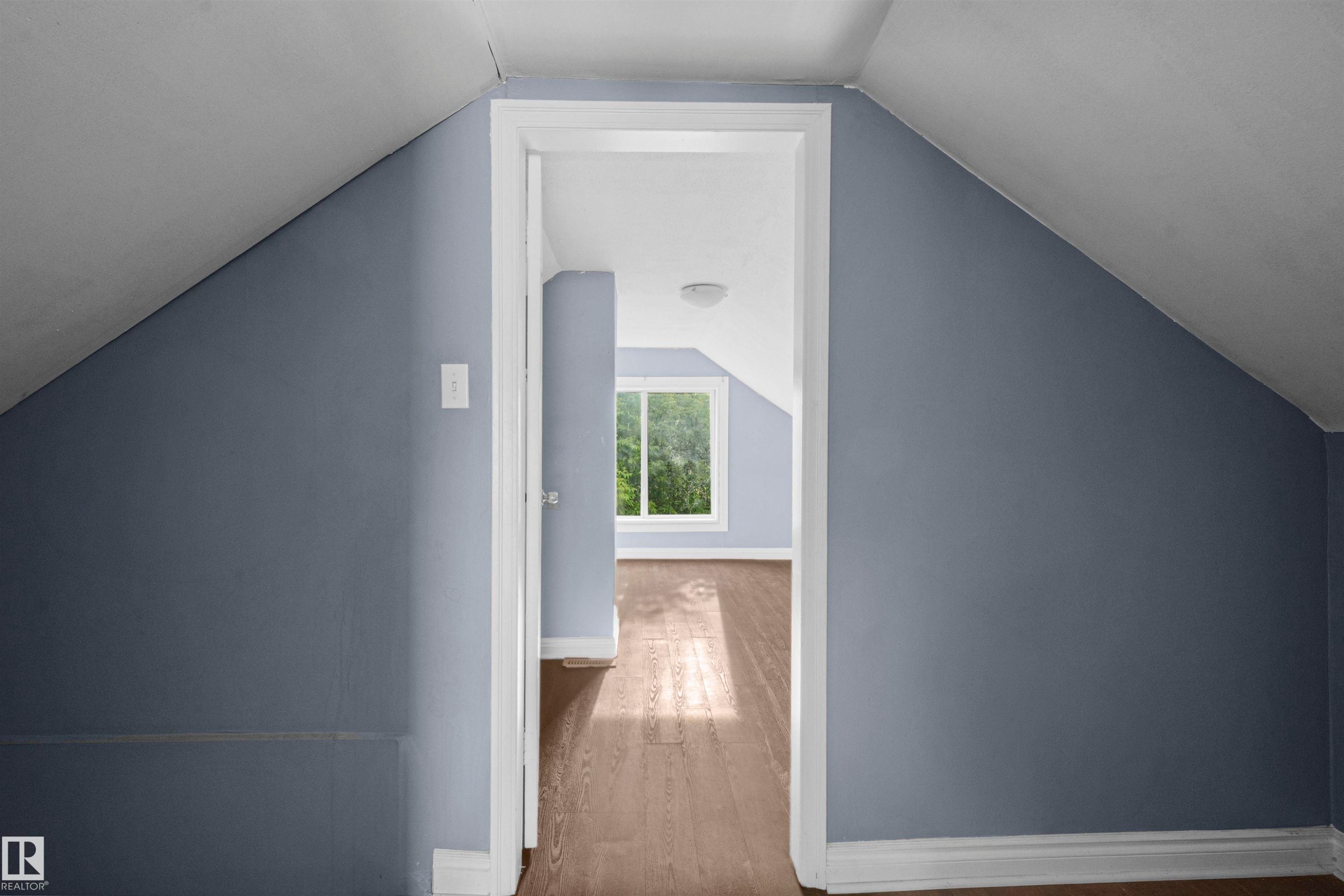 Attic space with sloped ceilings and light blue-gray wall finish - 7520 106 Street, Edmonton, AB