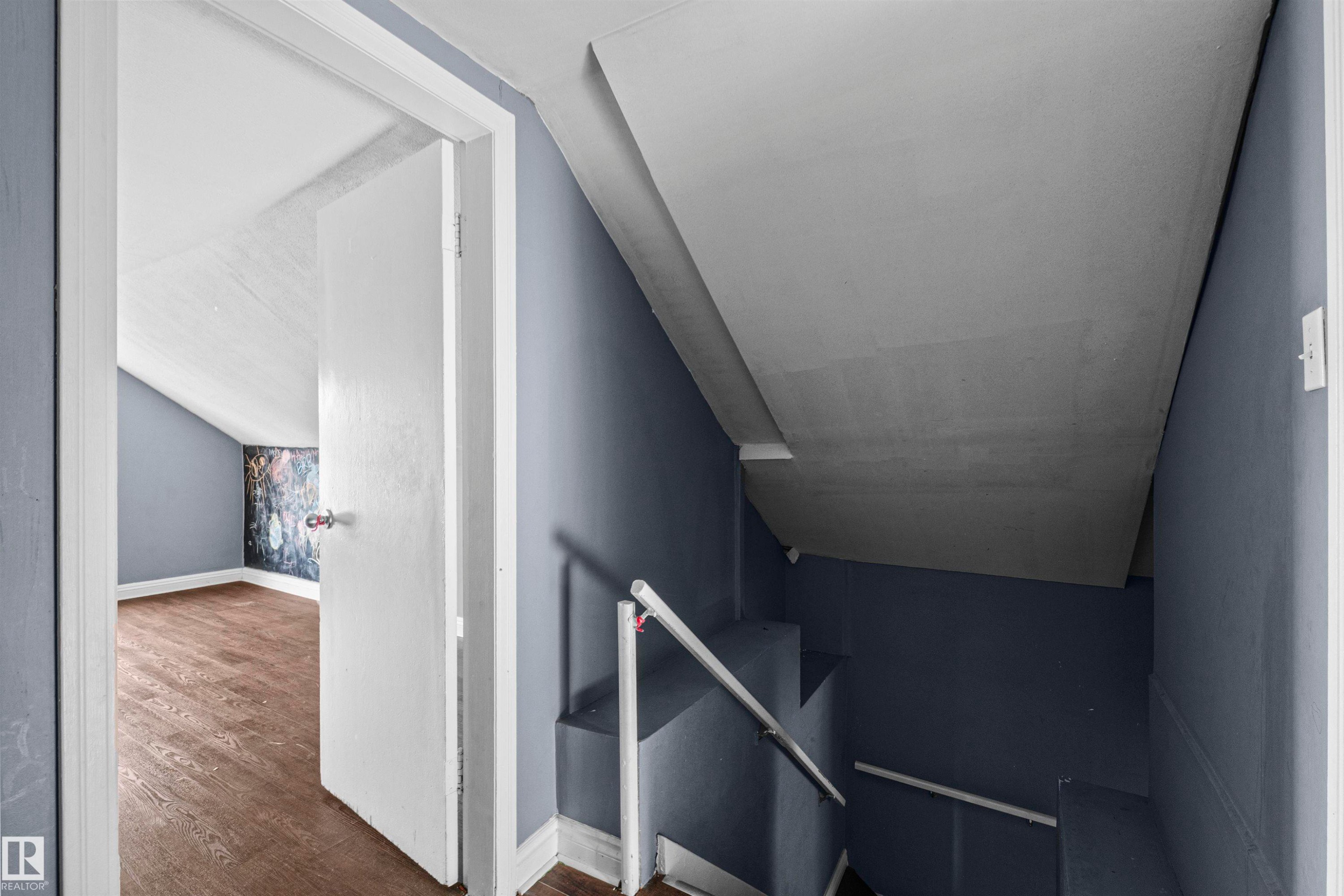 Interior staircase with a white handrail - 7520 106 Street, Edmonton, AB