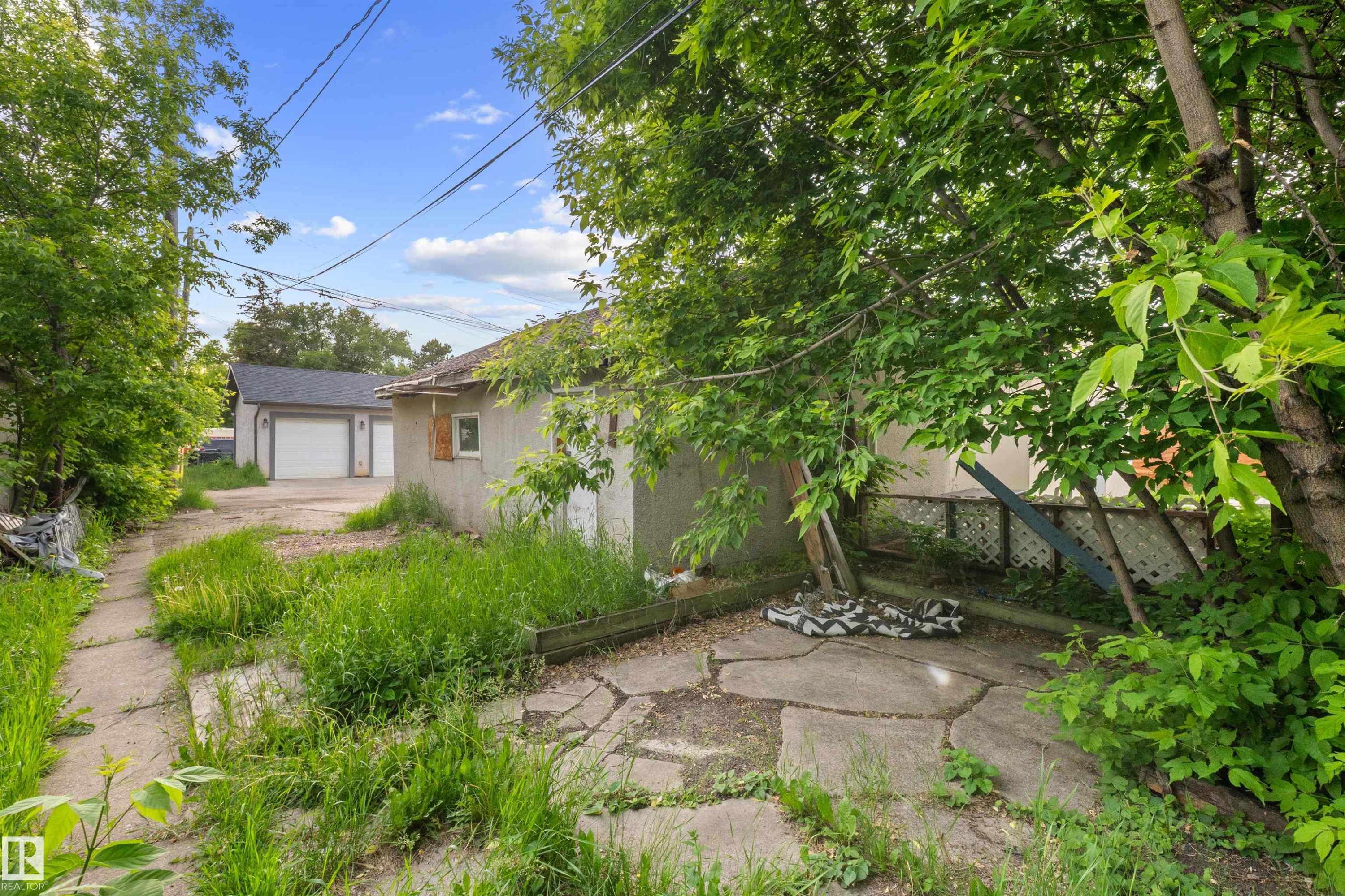 Detached garage with two white garage doors and a grey shingled roof - 7520 106 Street, Edmonton, AB