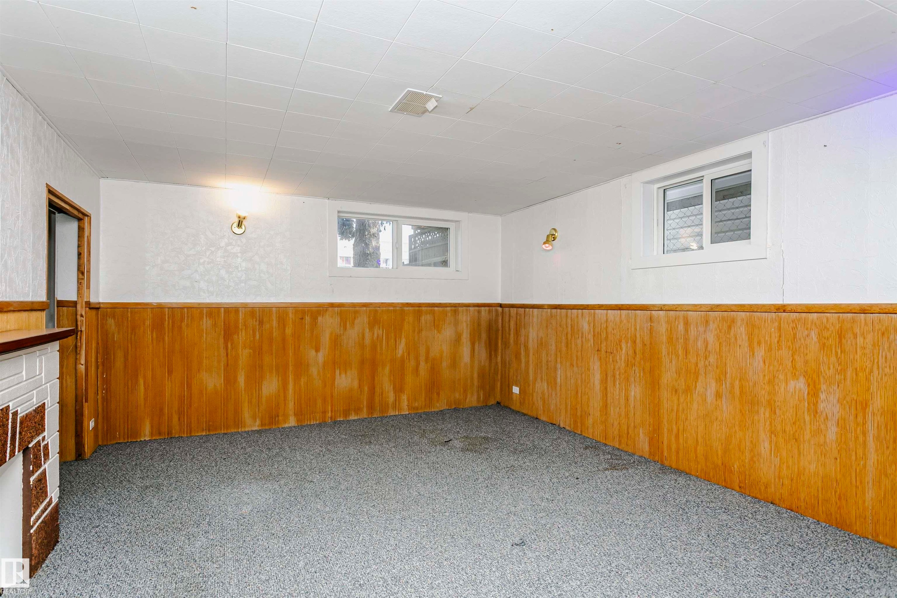 Finished room featuring wood-panel wainscoting, white walls, and a dropped ceiling with recessed lighting - 10035 81 Avenue Nw, Edmonton, AB - Indoor Photo Showing Other Room